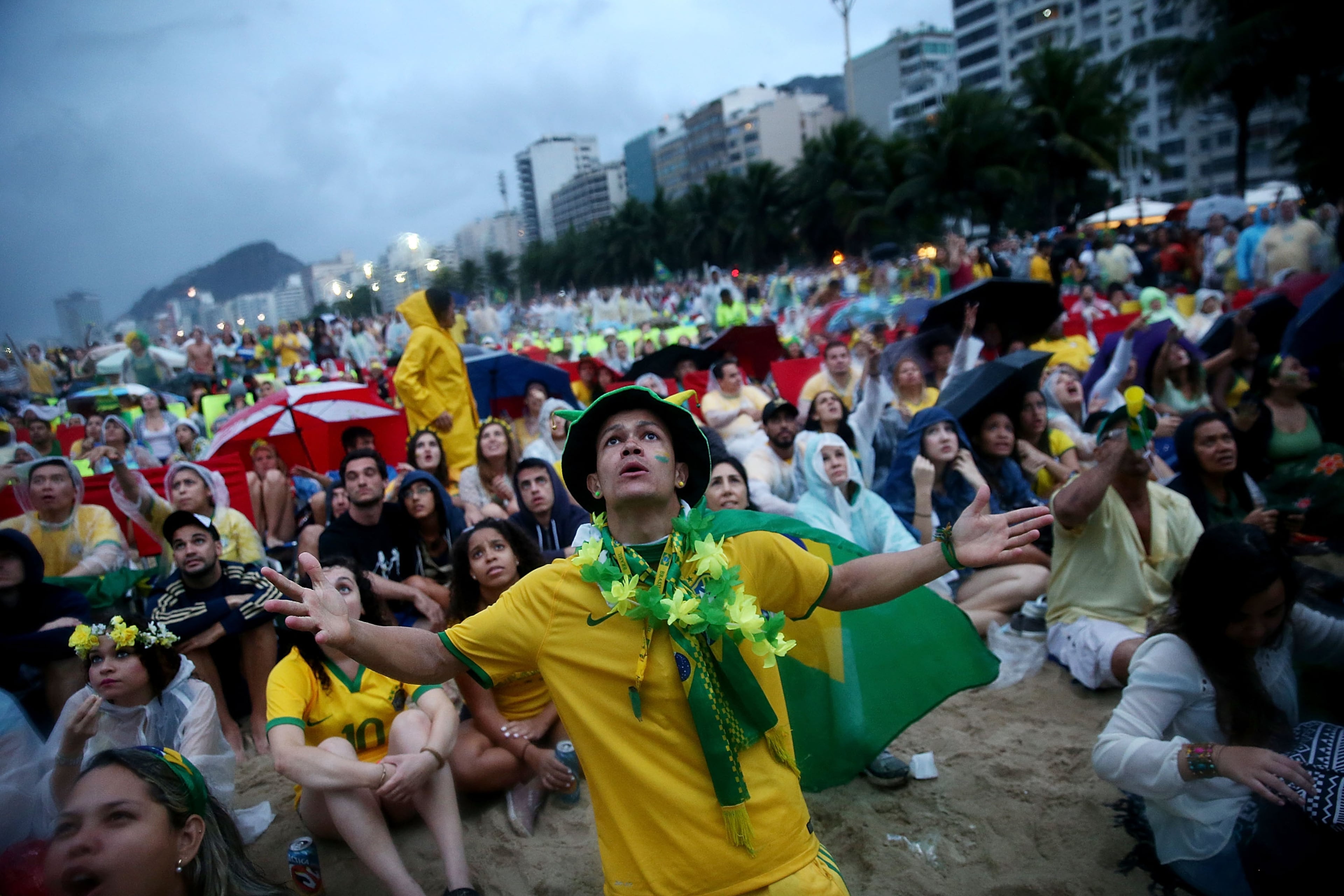 Brazil fans watch the first half on Copacabana Beach during the 2014 FIFA World Cup semifinal match between Brazil and Germany on July 8, 2014 in Rio de Janeiro, Brazil. (Photo by Mario Tama/Getty Images)
