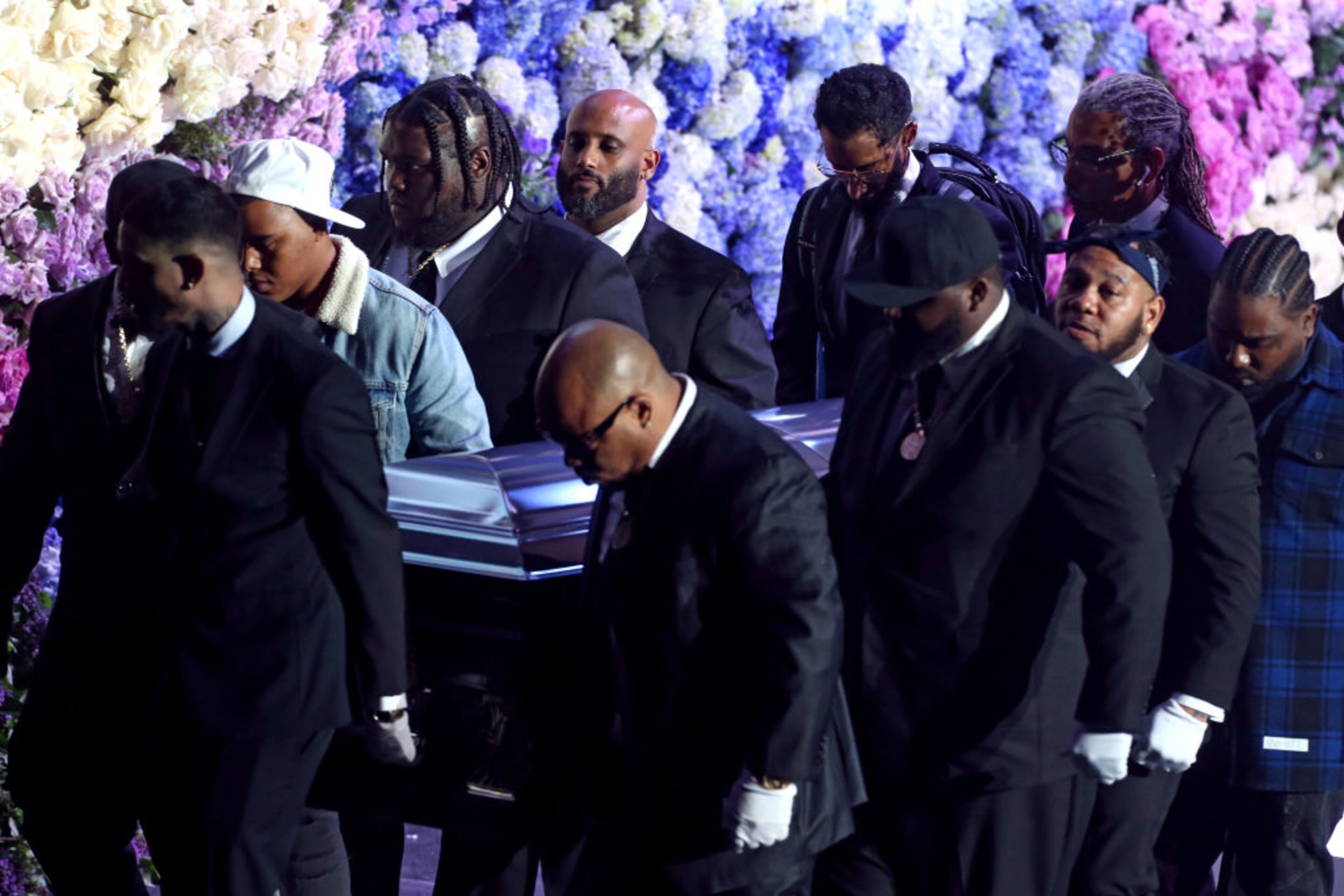 LOS ANGELES, CALIFORNIA - APRIL 11: (EDITORS NOTE: All images taken by Getty Images inside the Staples Center at Nipsey Hussle's Celebration of Life have been reviewed and approved for distribution by Atlantic Records) Pallbearers carry the casket off stage during Nipsey Hussle's Celebration of Life at STAPLES Center on April 11, 2019 in Los Angeles, California. Nipsey Hussle was shot and killed in front of his store, The Marathon Clothing, on March 31, 2019 in Los Angeles. (Photo by Frederick M. Brown/Getty Images For Atlantic Records )