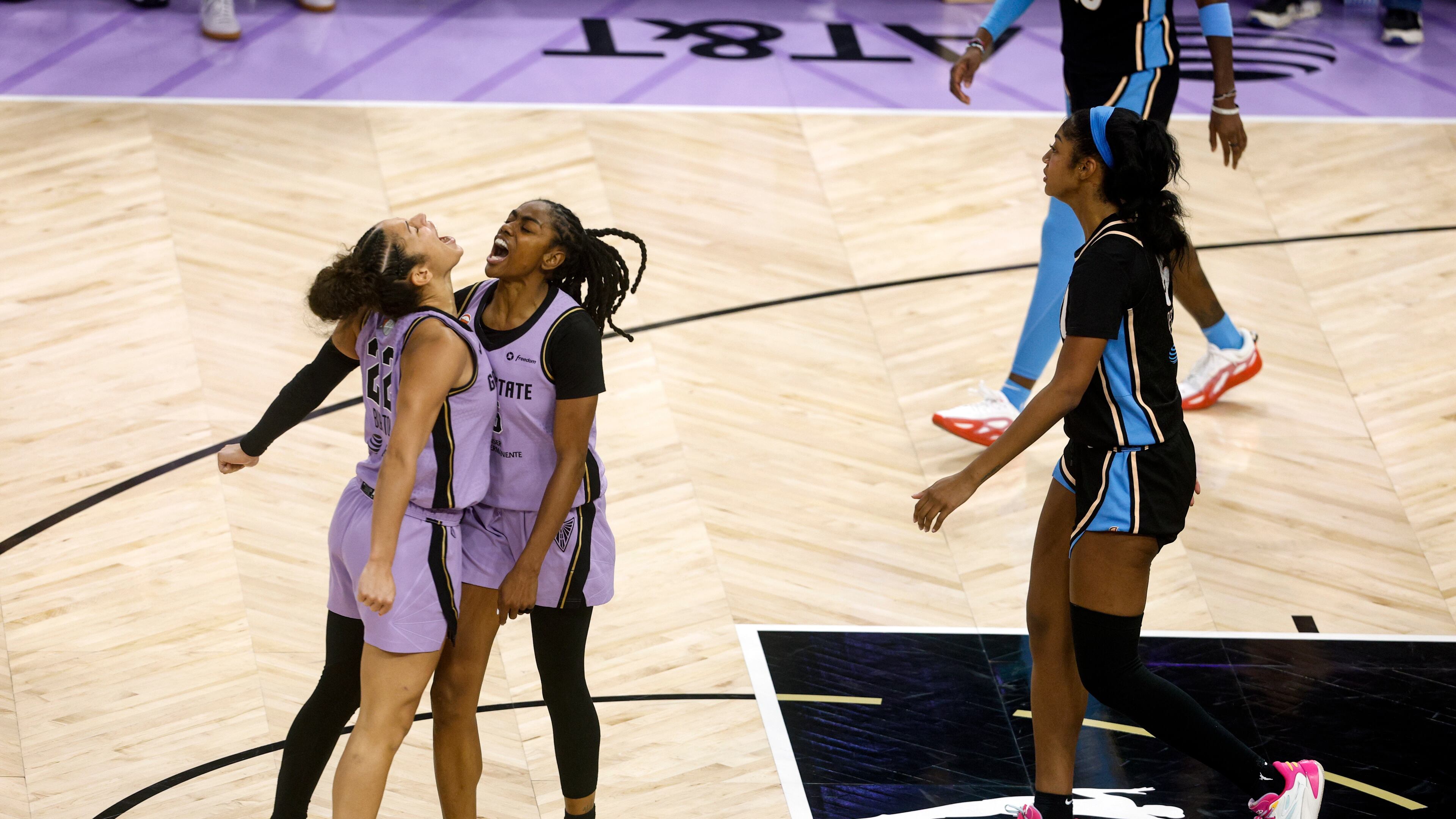 Golden State Valkyries guard Tiffany Hayes (15) celebrates with guard Veronica Burton (22) after scoring against Atlanta Dream forward Angel Reese (5) during the second half of Game 5 of the WNBA basketball finals in San Francisco, Monday, Oct. 26, 2026. (Yalonda M. James/San Francisco Chronicle via AP)