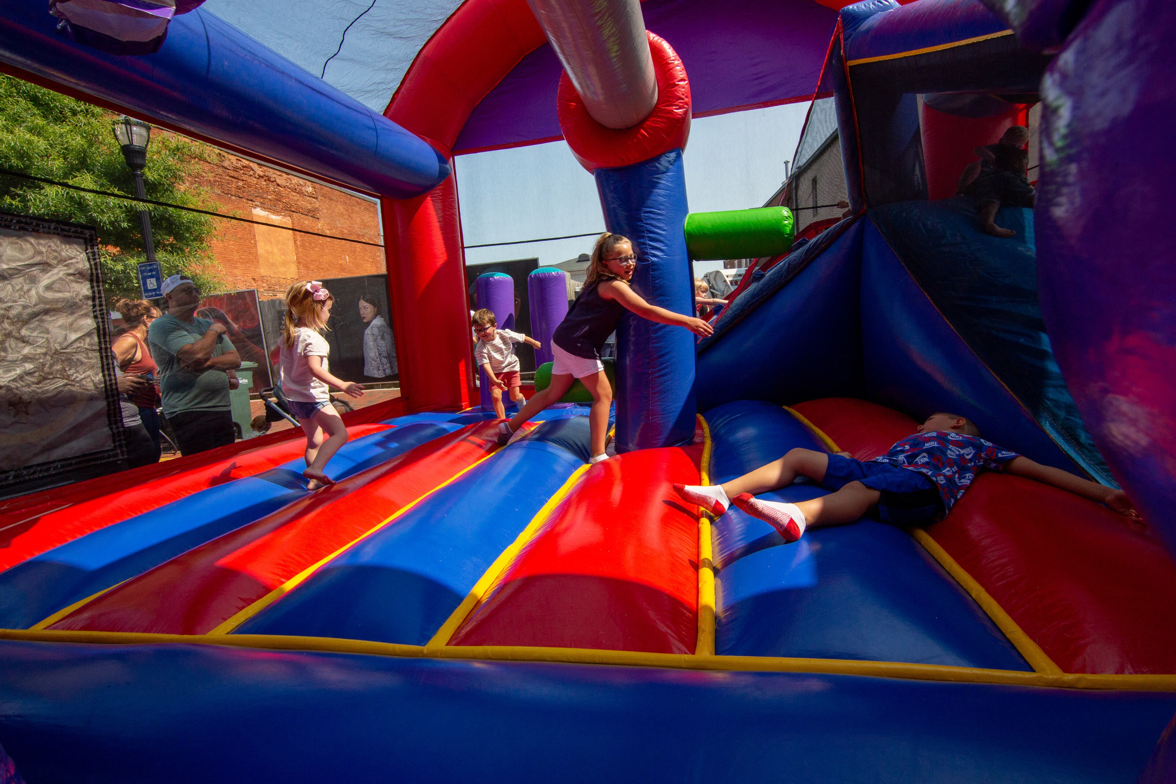 Kids play in one of the attractions in Marietta Square during the city's Independence Day weekend celebrations on Saturday, July 3, 2021. (Photo: Steve Schaefer for The Atlanta Journal-Constitution)