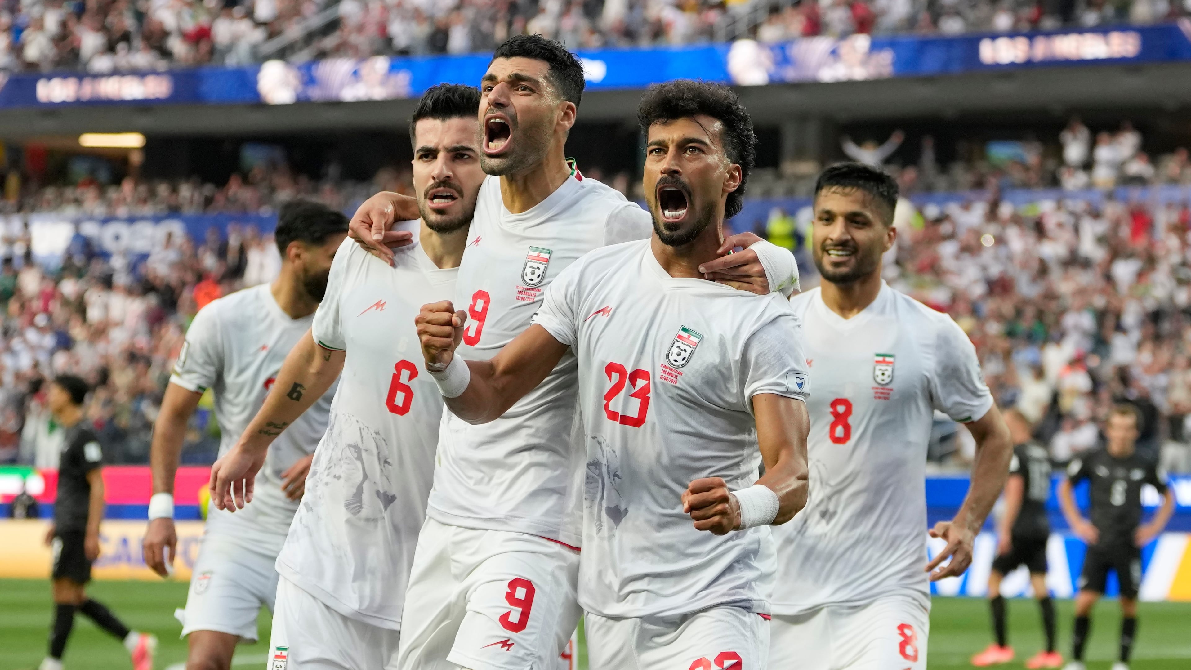 Iran's Ramin Rezaeian (23) celebrates with his teammates after scoring a goal during the World Cup Group G soccer match between Iran and New Zealand in Inglewood, Calif., near Los Angeles, Monday, June 15, 2026. (AP Photo/Andre Penner)