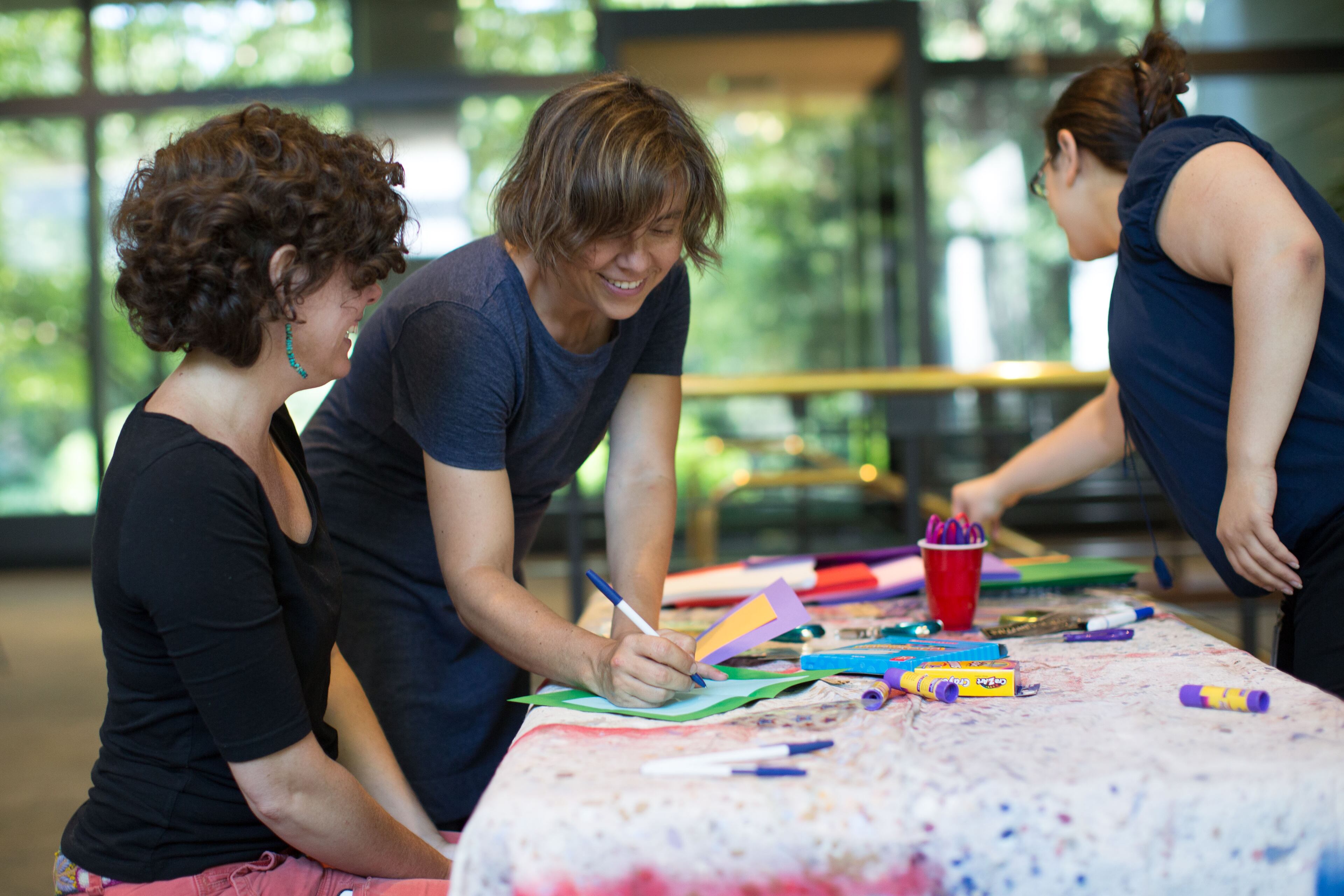 Holly Hollingsworth, left, Charlotte Swancy, center, and Danielle Bevacqua create "Get Well" cards for former President Jimmy Carter at the Carter Presidential Library in Atlanta, Saturday, Aug. 15, 2015. Carter announced earlier this week that he has cancer that it has spread to other parts of his body. BRANDEN CAMP/SPECIAL