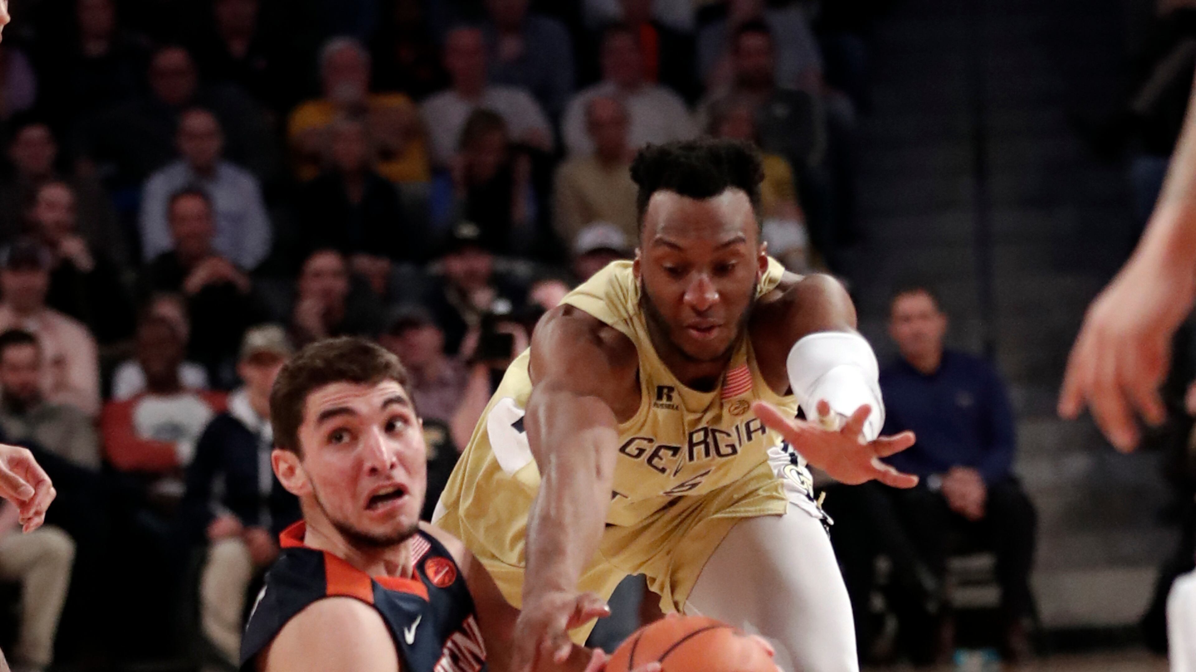 Virginia guard Ty Jerome (11) comes up with the ball against Georgia Tech guard Josh Okogie (5) during the first second of an NCAA college basketball game Thursday, Jan. 18, 2018, in Atlanta. (AP Photo/John Bazemore)