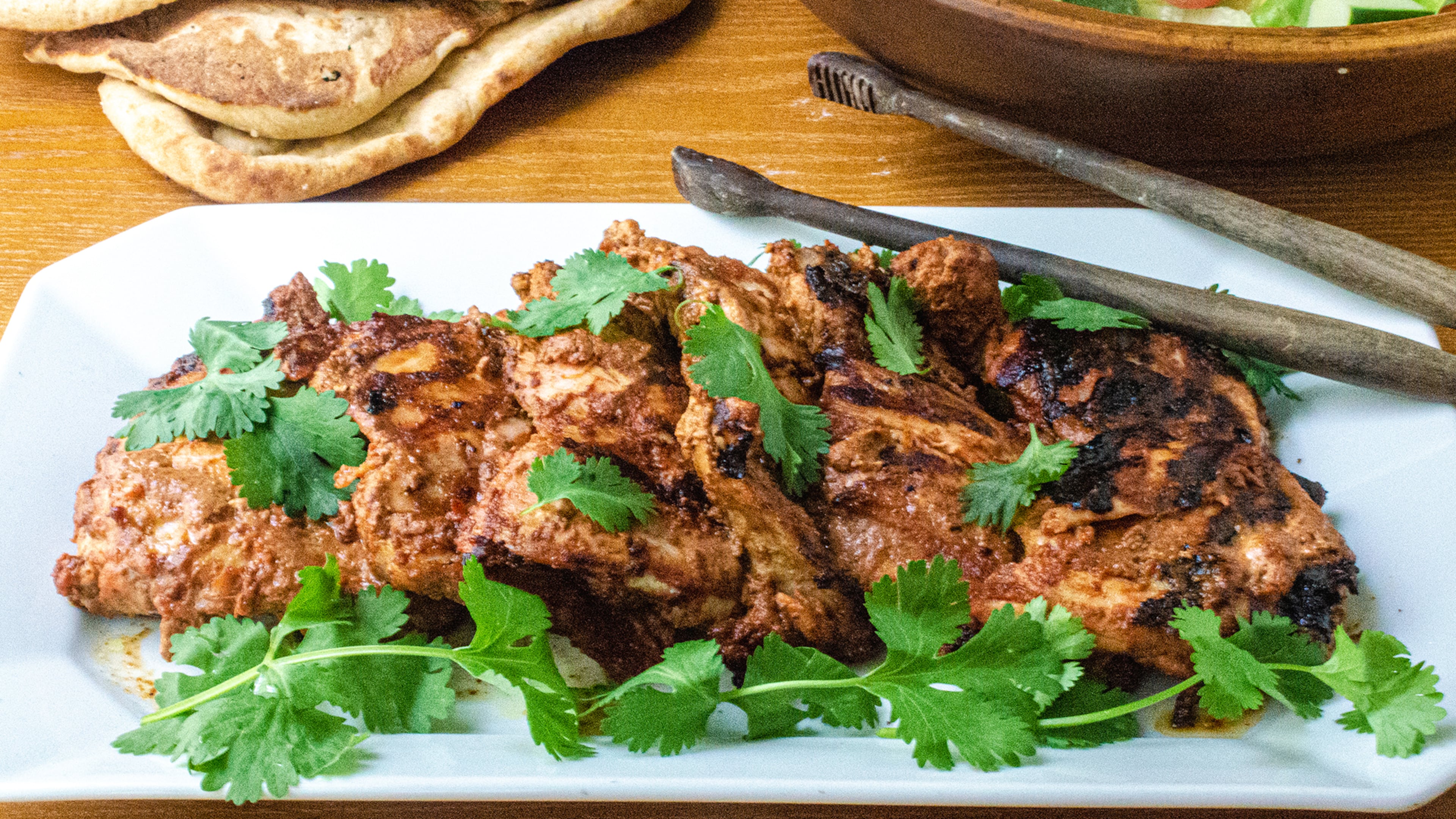 A marinade of tandoori paste, yogurt and lime juice provide delicious flavor to chicken thighs.
(Virginia Willis for The Atlanta Journal-Constitution)