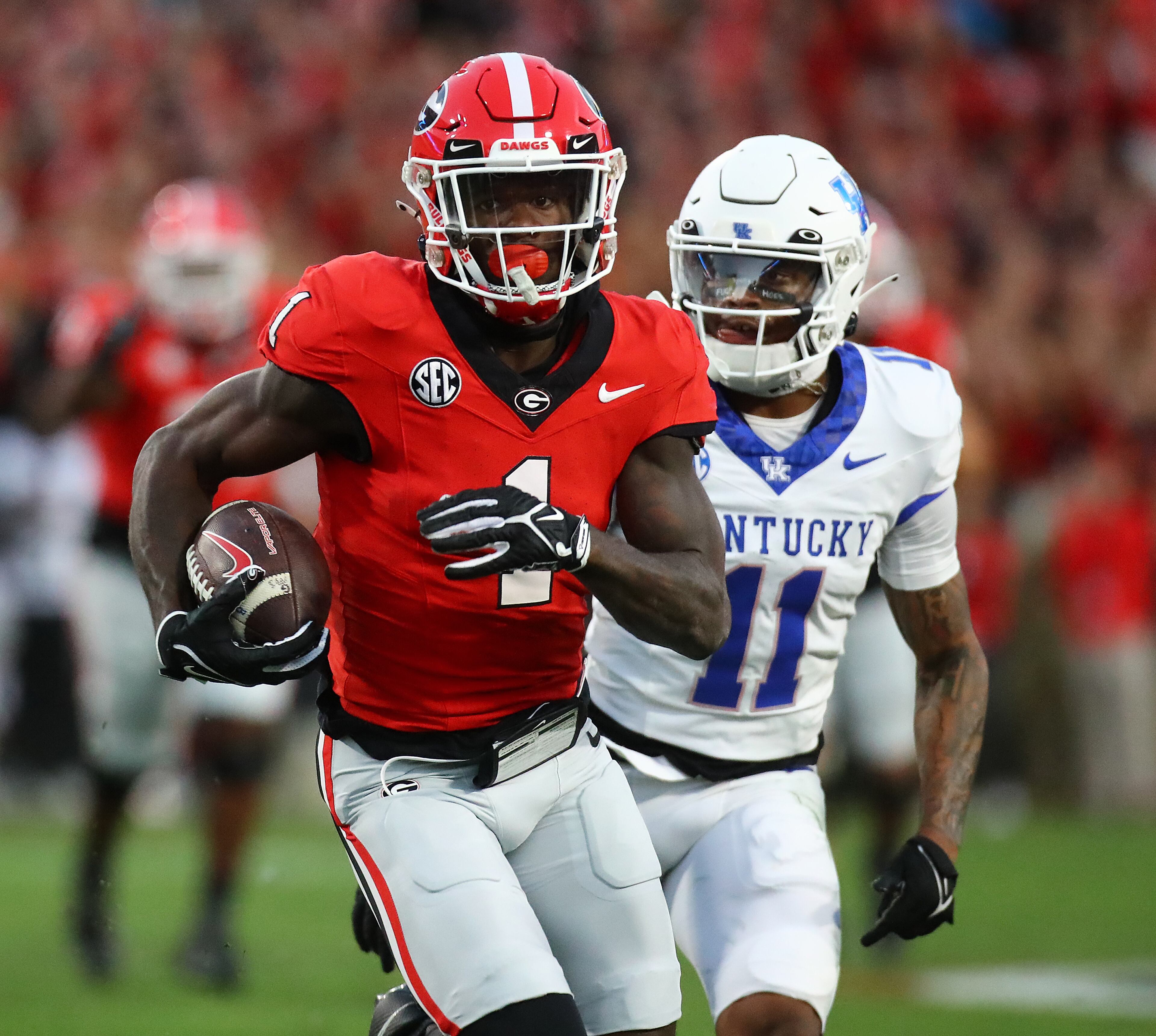 Georgia wide receiver Marcus Rosemy-Jacksaint breaks away from Kentucky defensive back Zion Childress for a touchdown to take a 7-0 lead during the first quarter in a NCAA college football game on Saturday, Oct. 7, 2023, in Athens. Curtis Compton for the Atlanta Journal Constitution