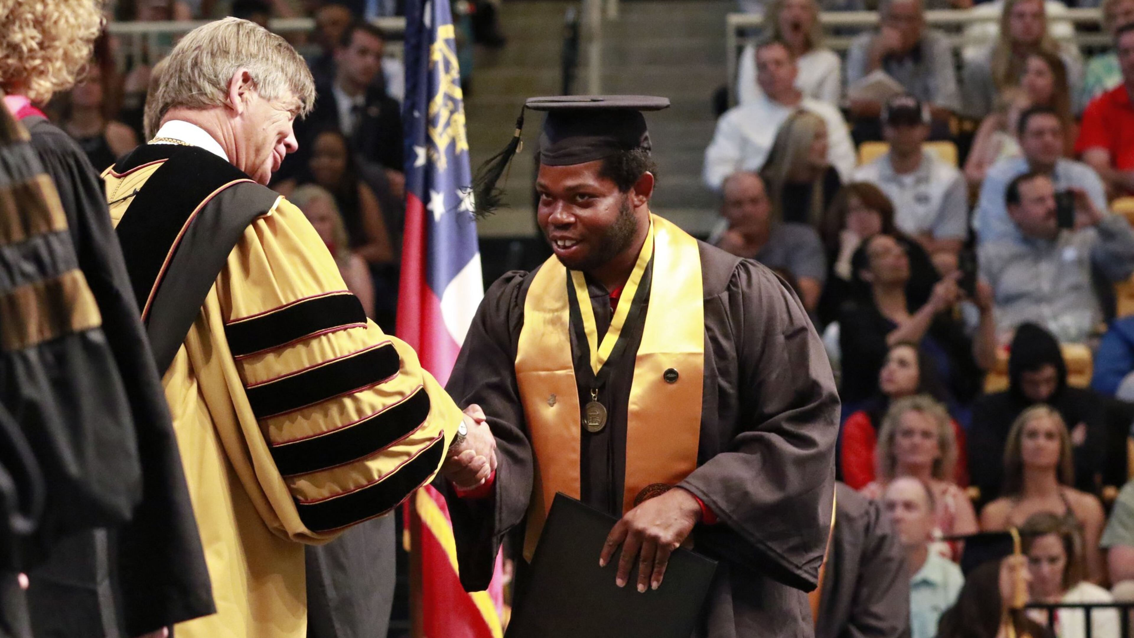 David Bennett is congratulated by University President Daniel Papp as he receives his Bachelor of Arts in Theatre and Performance Studies. Pass announced he is leaving the university after leading it for 10 years. BOB ANDRES / BANDRES@AJC.COM