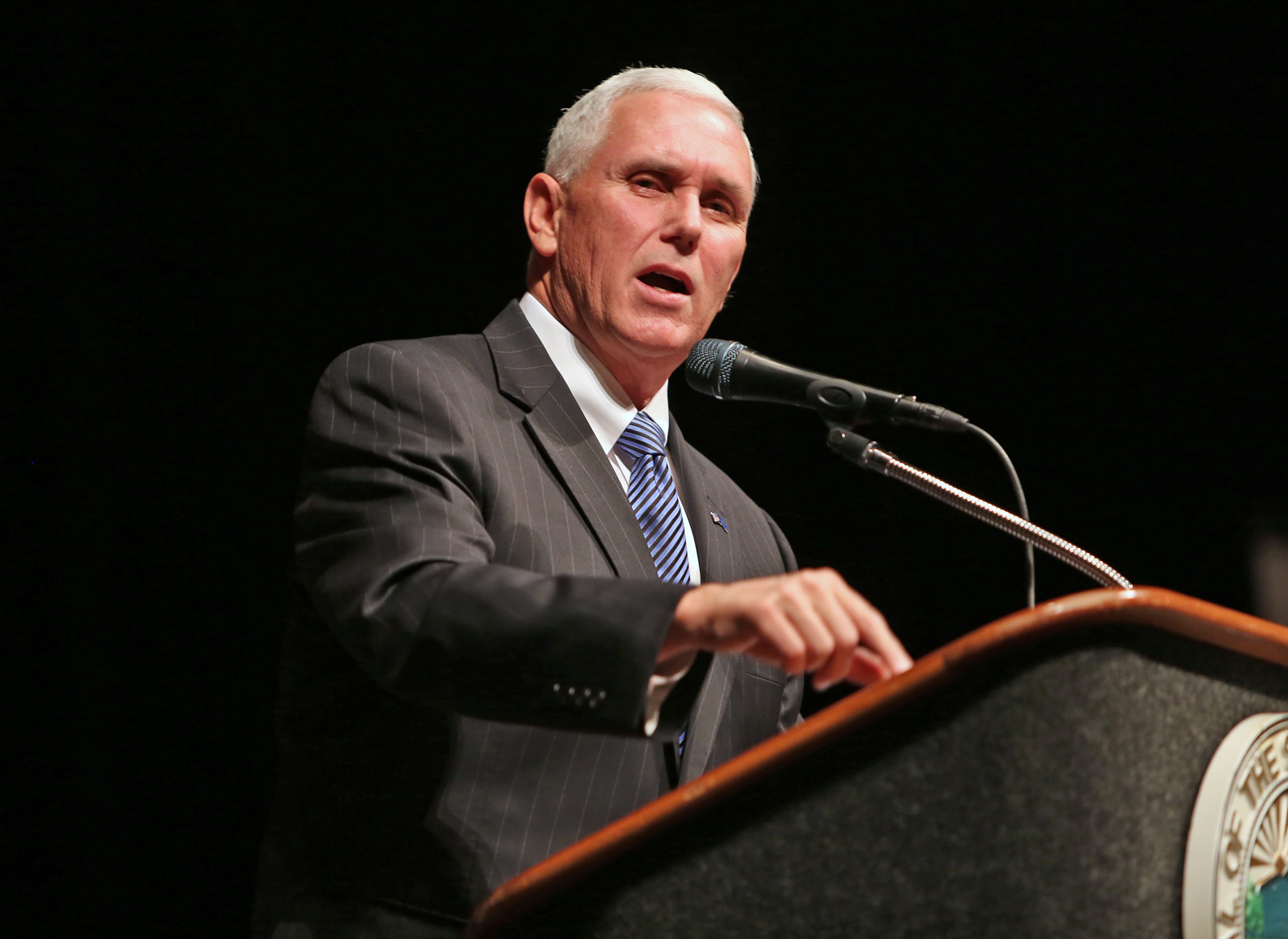 Governor Mike Pence unveils his 2015 legislative agenda during the Bingham Greenebaum Doll Legislative Conference at the Indiana Convention Center, in Indianapolis, Thursday, Dec. 4, 2014. (AP Photo/The Indianapolis Star, Kelly Wilkinson)