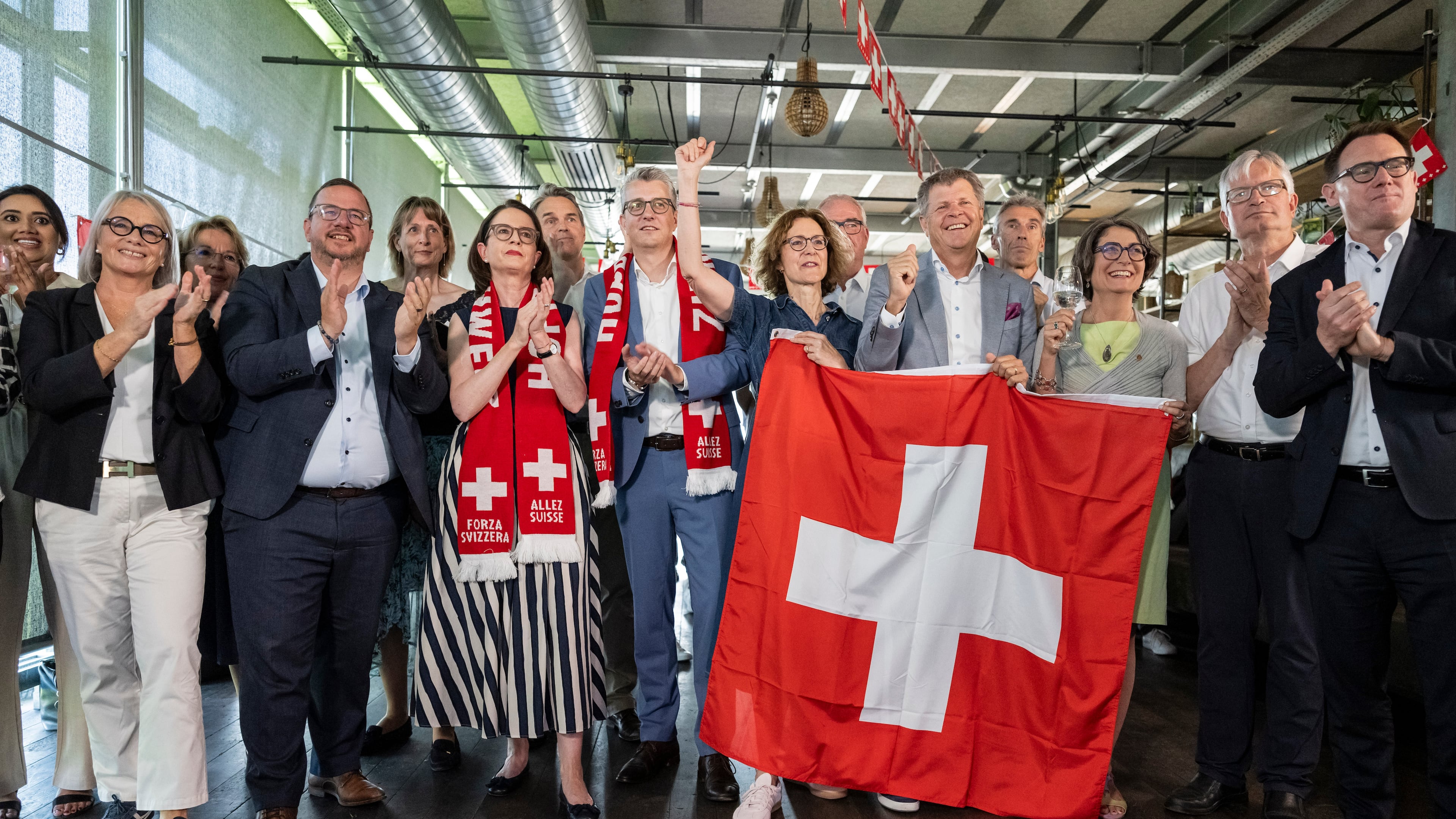 Members of the Federal Parliament and other representatives of civic organizations, celebrate during a get together of a cross-party alliance against the SVP's popular initiative "No 10-Million Switzerland" which the people and the cantons voted on this election Sunday, June 14, 2026, in Bern, Switzerland. (Alessandro della Valle/Keystone via AP)