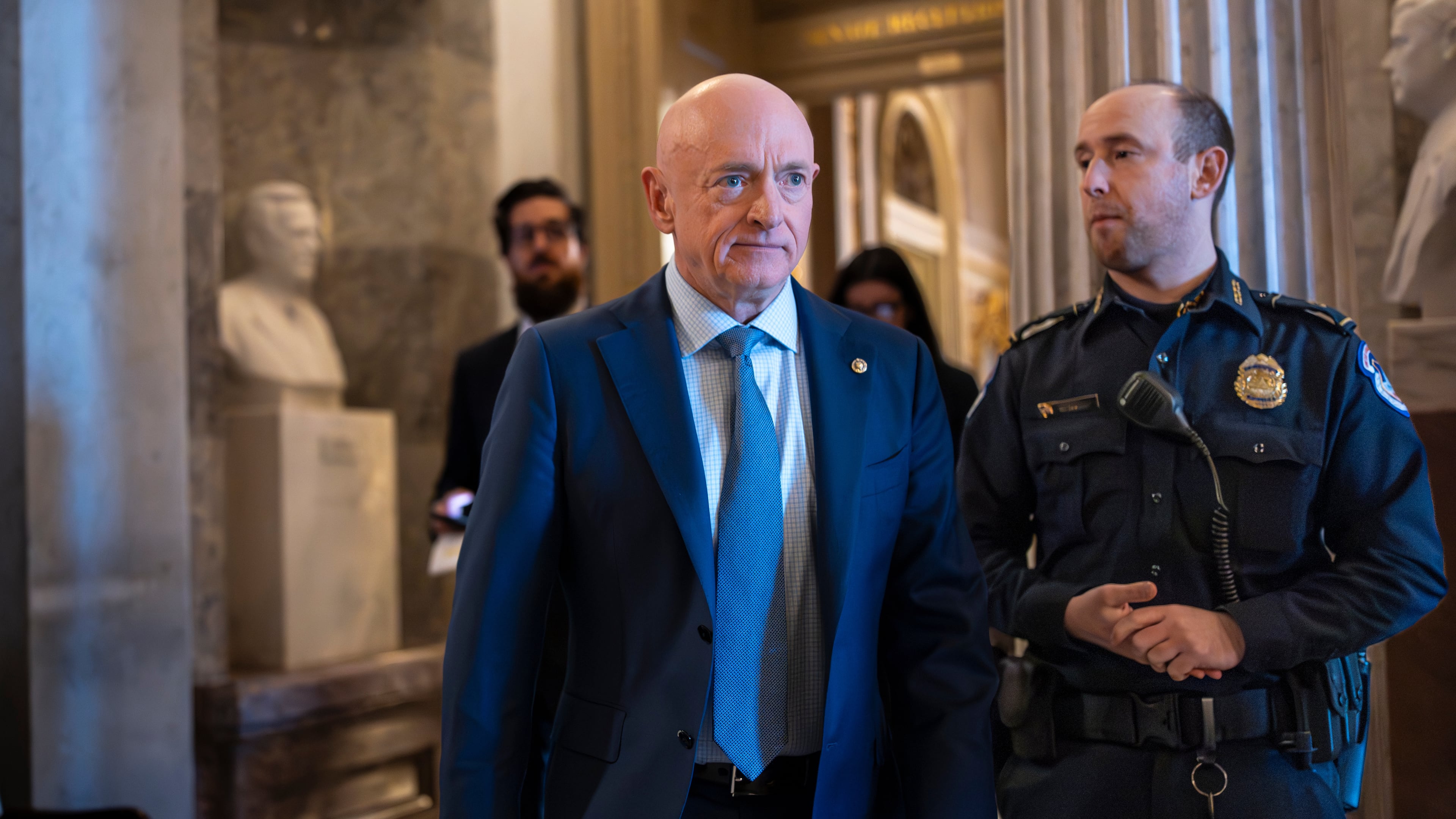 Sen. Mark Kelly, D-Ariz., exits the Senate chamber after speaking out against Defense Secretary Pete Hegseth's efforts to censure him over his participation in a video that called on troops to resist unlawful orders, at the Capitol in Washington, Monday, Jan. 12, 2026. (AP Photo/J. Scott Applewhite)