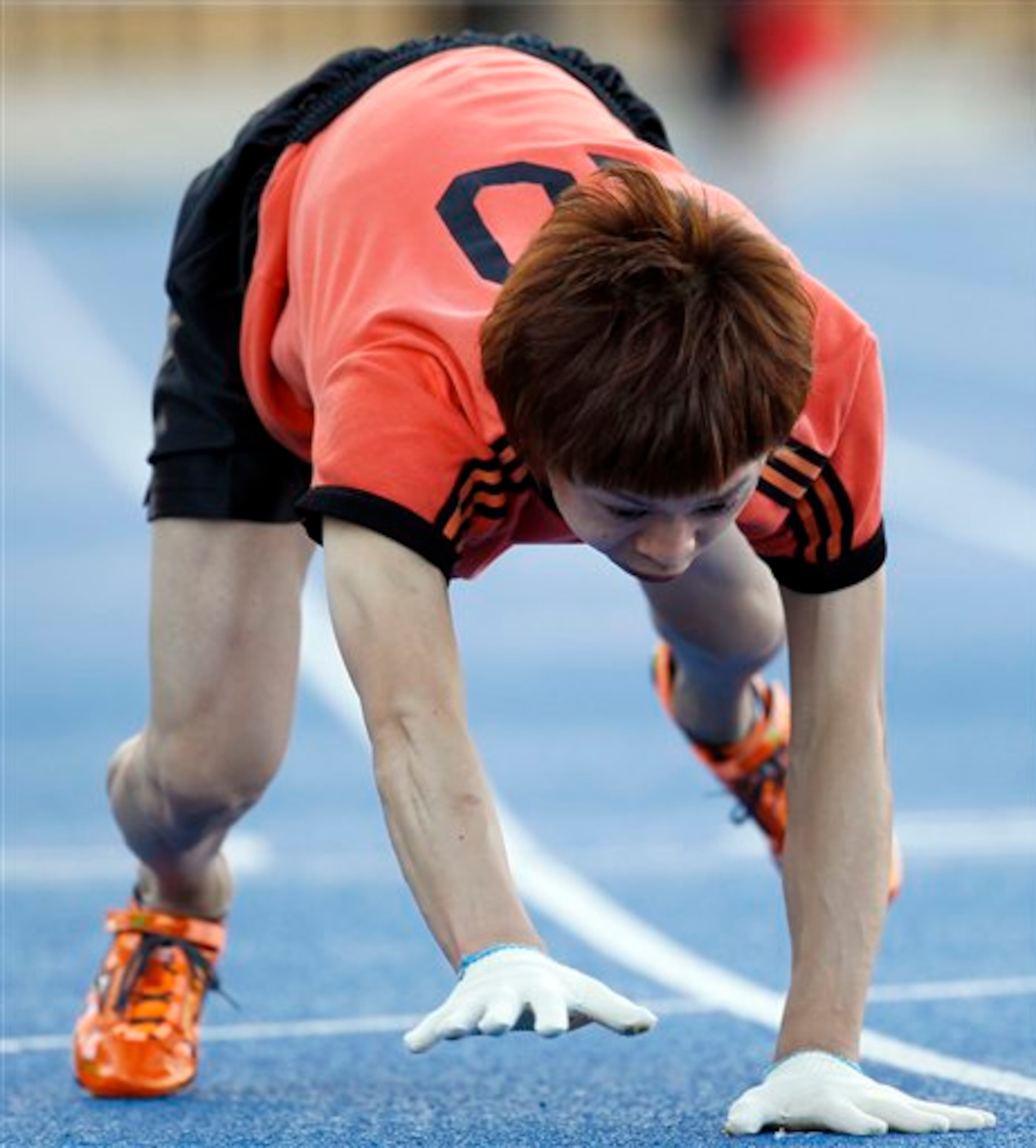 Kenichi Ito runs on a race course on his way to setting the Guinness World Record for the fastest time to run 100 meters on all fours at Komazawa Olympic Park Stadium in Tokyo Thursday, Nov. 15, 2012. Known as "Monkey Man," Ito, 30, who has trained the four-legged style walking and running for nine years in his daily life by studying primates' movements through books, video and visiting the zoo frequently, ran in 17.47 seconds, 1.11 seconds faster than the time he set in 2008. (AP Photo/Koji Sasahara)