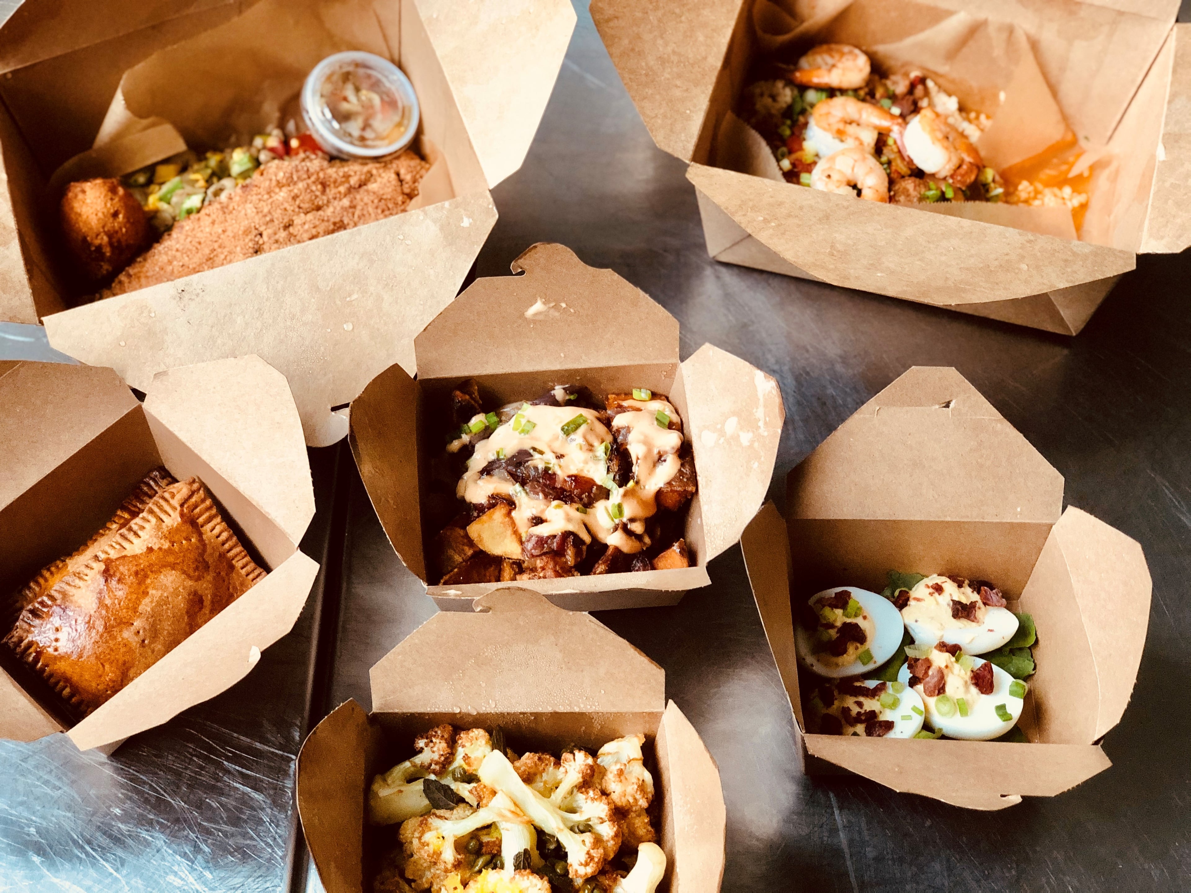 Led by executive chef Elodie Westover, Full Commission in Grant Park offers stellar takeout. Shown here, clockwise from top left: fried catfish, jambalaya, deviled eggs, cauliflower, Jamaican beef patties, and "animal-style" home fries (with bacon-onion jam and special sauce).
Courtesy of Wendell Brock