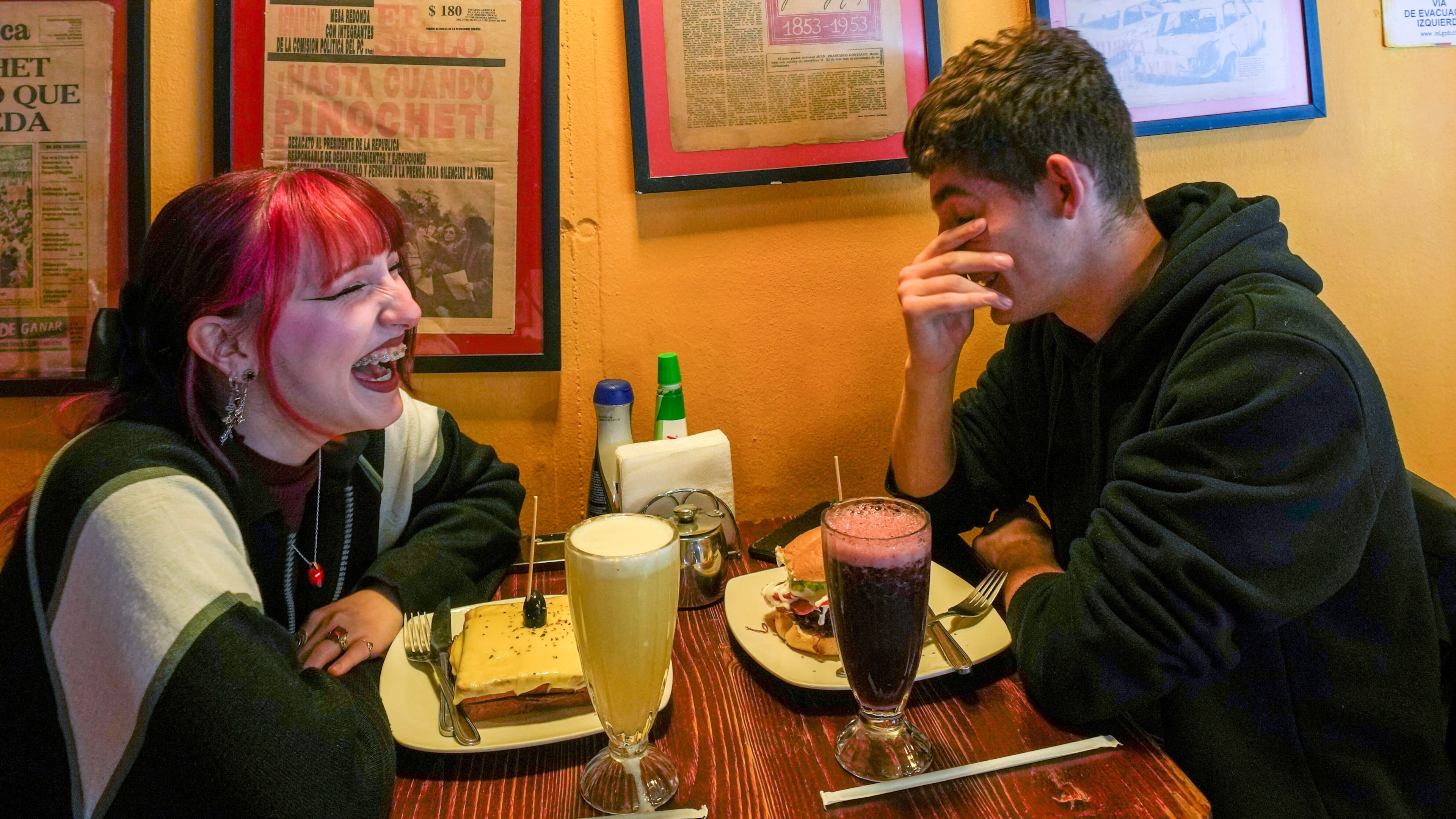 FILE - A couple sit in a cafe in Santiago, Chile, on Nov. 6, 2025. (AP Photo/Esteban Felix, File)