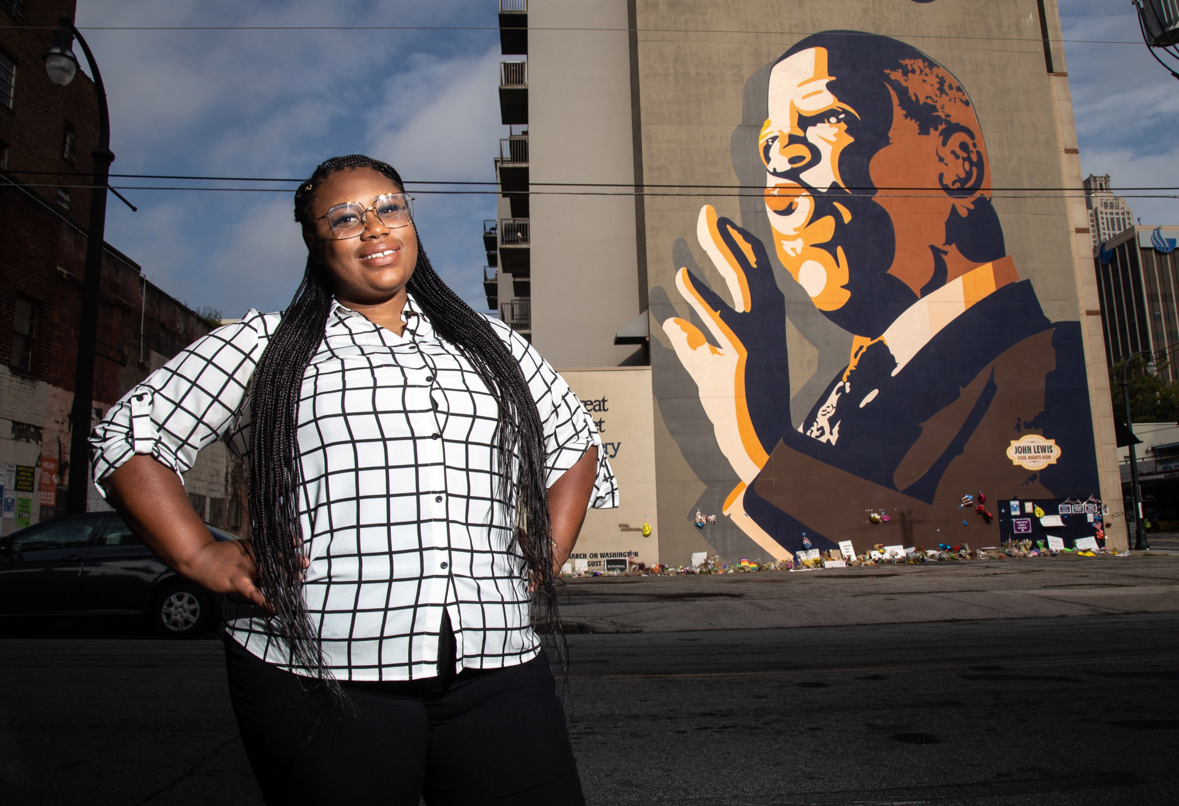 Mary-Pat Hector poses for a photograph in front of the John Lewis mural on Auburn Ave in Atlanta, August 6, 2020. STEVE SCHAEFER FOR THE ATLANTA JOURNAL-CONSTITUTION