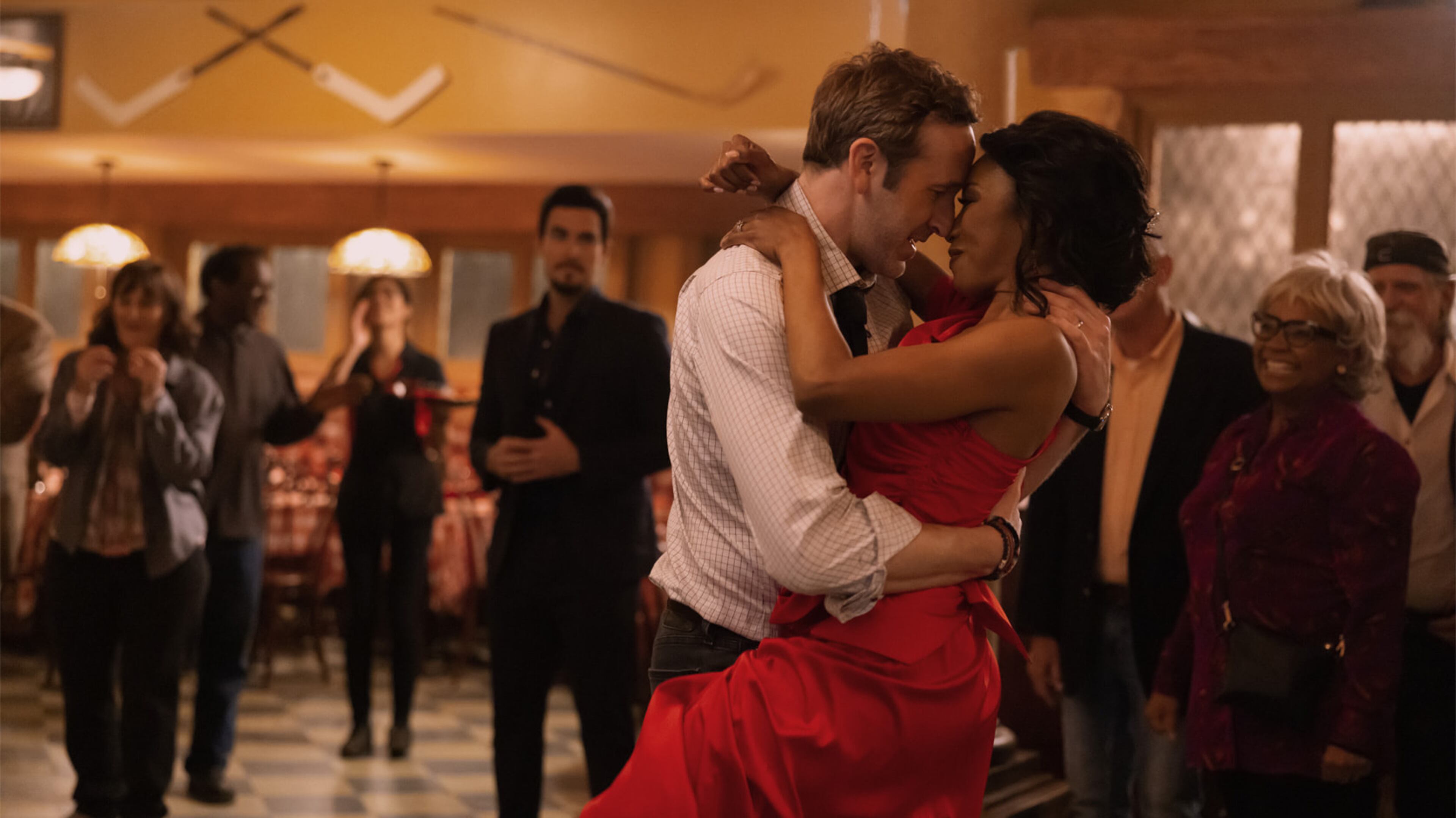 Gabrielle Dennis and Chris O’Dowd in "The Big Door Prize," now streaming on Apple TV+. Josh Segarra is in the background. APPLE TV+