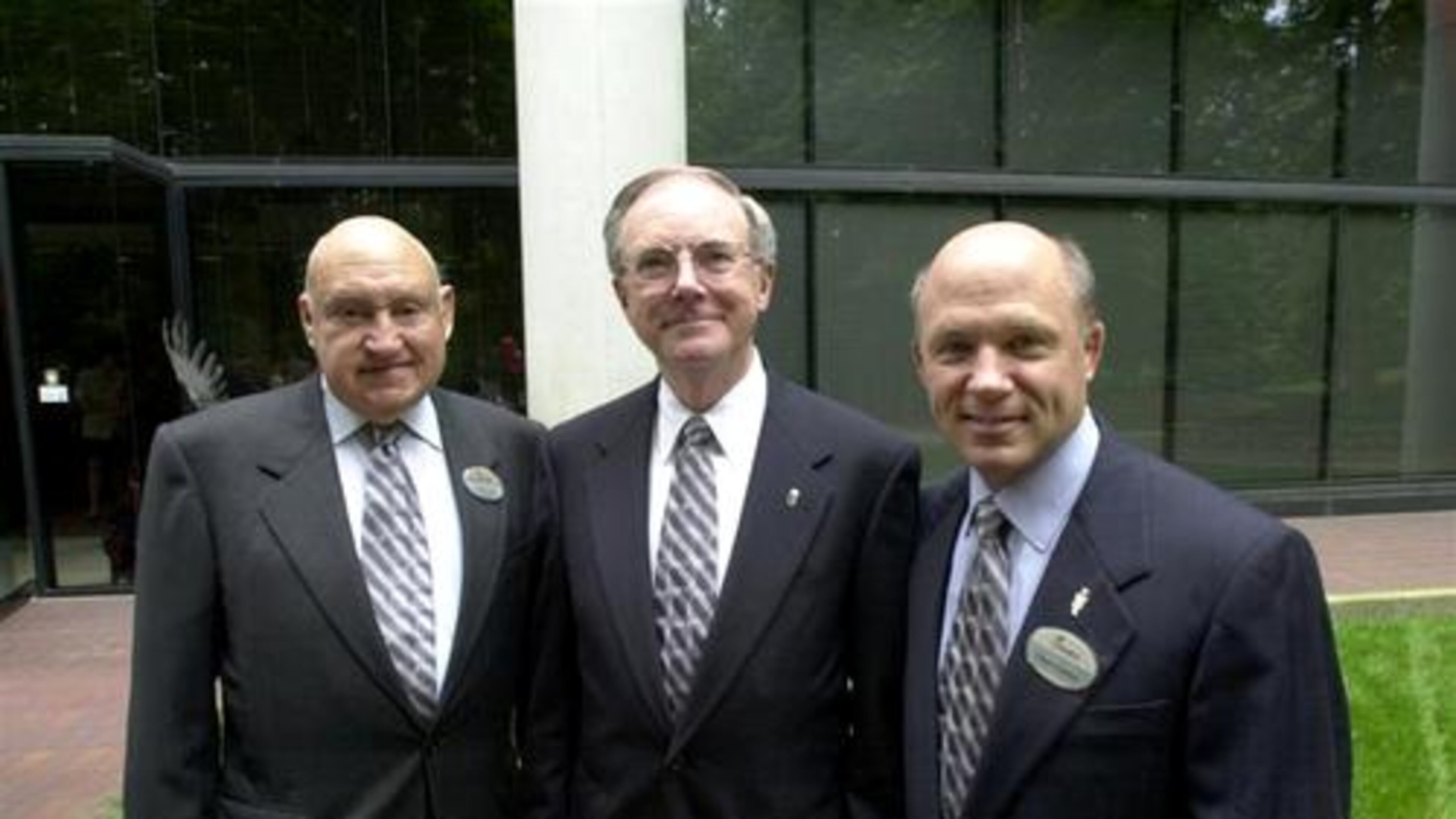 Chick-fil-A execs pose for a photo before entering their Atlanta headquarters to attend a function for outgoing president Jimmy Collins (center) in 2001. S. Truett Cathy (left) opened the Dwarf Grill (later the Dwarf House) in 1946 in Hapeville. The first Chick-fil-A was opened in 1967 at the Greenbriar Mall in South Atlanta. Truett's son Dan Cathy (right) continues the family tradition as company president.