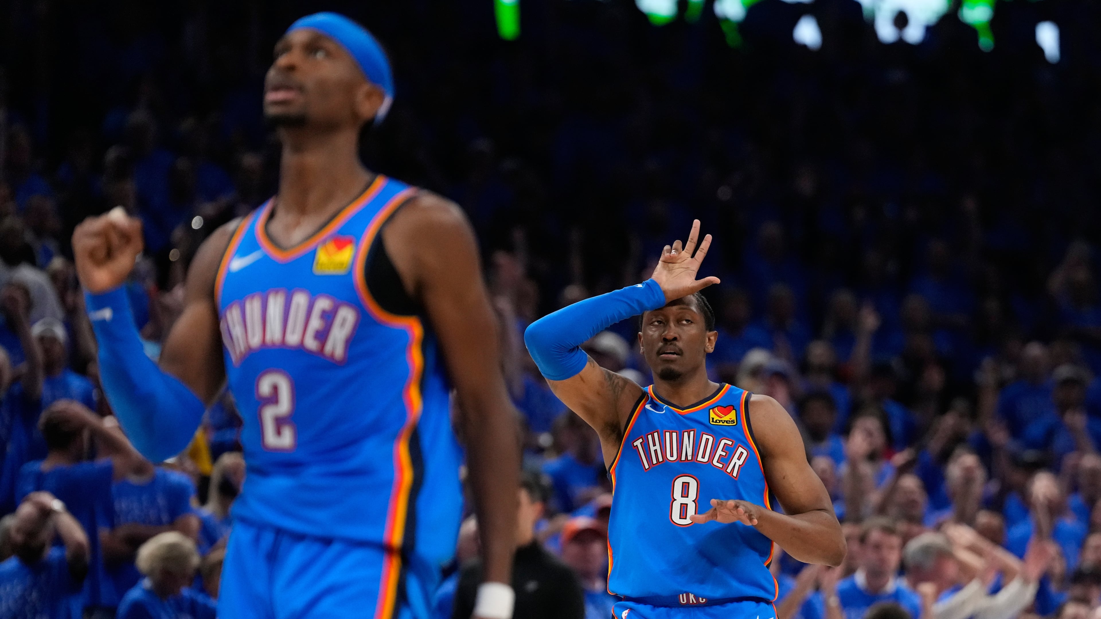 Oklahoma City Thunder guard Jalen Williams (8) and guard Shai Gilgeous-Alexander (2) celebrate after a 3-pointer during the second overtime of Game 1 in a third-round NBA basketball playoffs series against the San Antonio Spurs Monday, May 18, 2026, in Oklahoma City. (AP Photo/Tony Gutierrez)