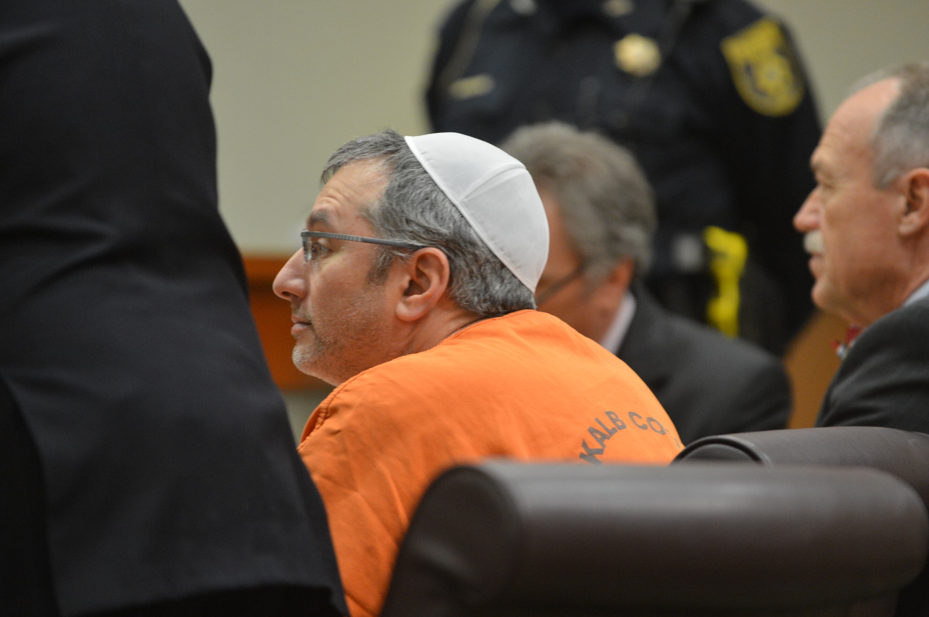 Hemy Neuman entered court shortly before 1:30 p.m. Tuesday, wearing an orange DeKalb County jumpsuit. He sat at the defense table with his attorneys, Doug Peters and Bob Rubin. DeKalb Superior Court Judge Gregory A. Adams presided.