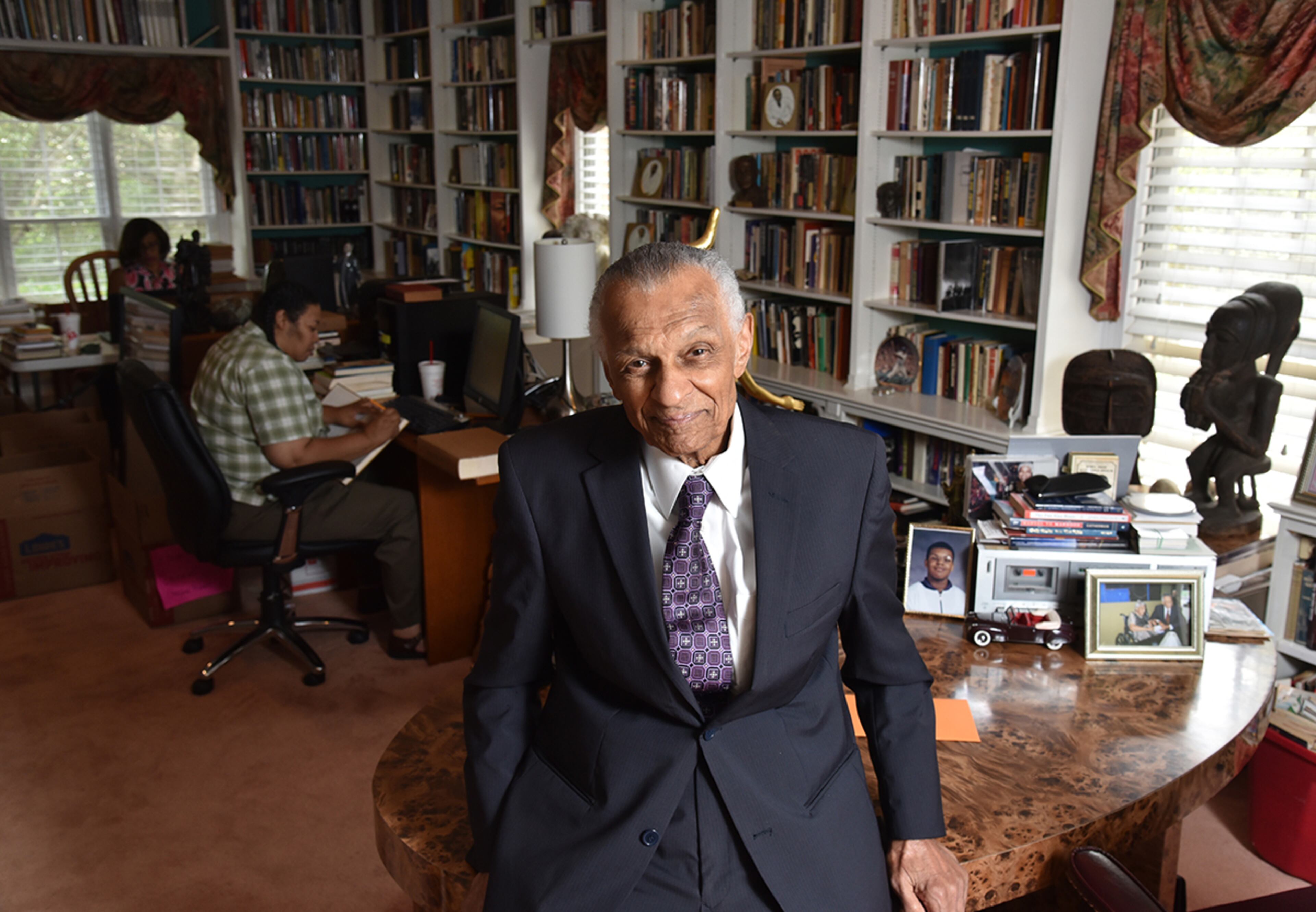 July 25, 2017 Atlanta - Portrait of C.T. Vivian at his home library as his daughter Charisse Thornton (background) and Dawnn Mitchell work on checking inventory on Tuesday, July 25, 2017. The National Monuments Foundation will be acquiring and managing the world-class library of Atlanta Civil Rights icon, C.T. Vivian. The library will be housed in the new Cook Park in Vine City. Vivian lived in the same Vine City neighborhood that will border Cook Park where his library is to be constructed under a 101-foot Peace Column. The 6,000 volume C.T. Vivian Library is one of the most impressive private collections in the city. HYOSUB SHIN / HSHIN@AJC.COM