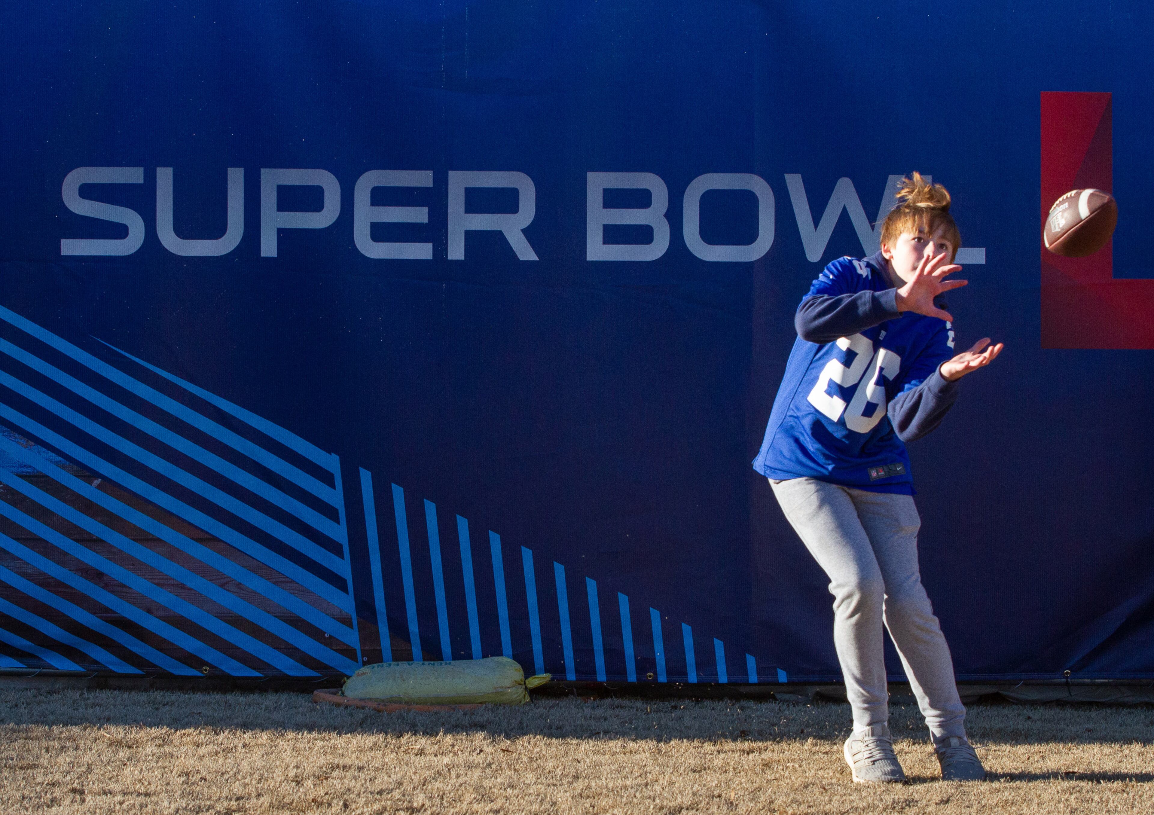 Owen Almassy catches a football at the Super Bowl LIVE presented by Verizon at the Centennial Olympic Park in downtown Atlanta January 31, 2019. STEVE SCHAEFER / SPECIAL TO THE AJC