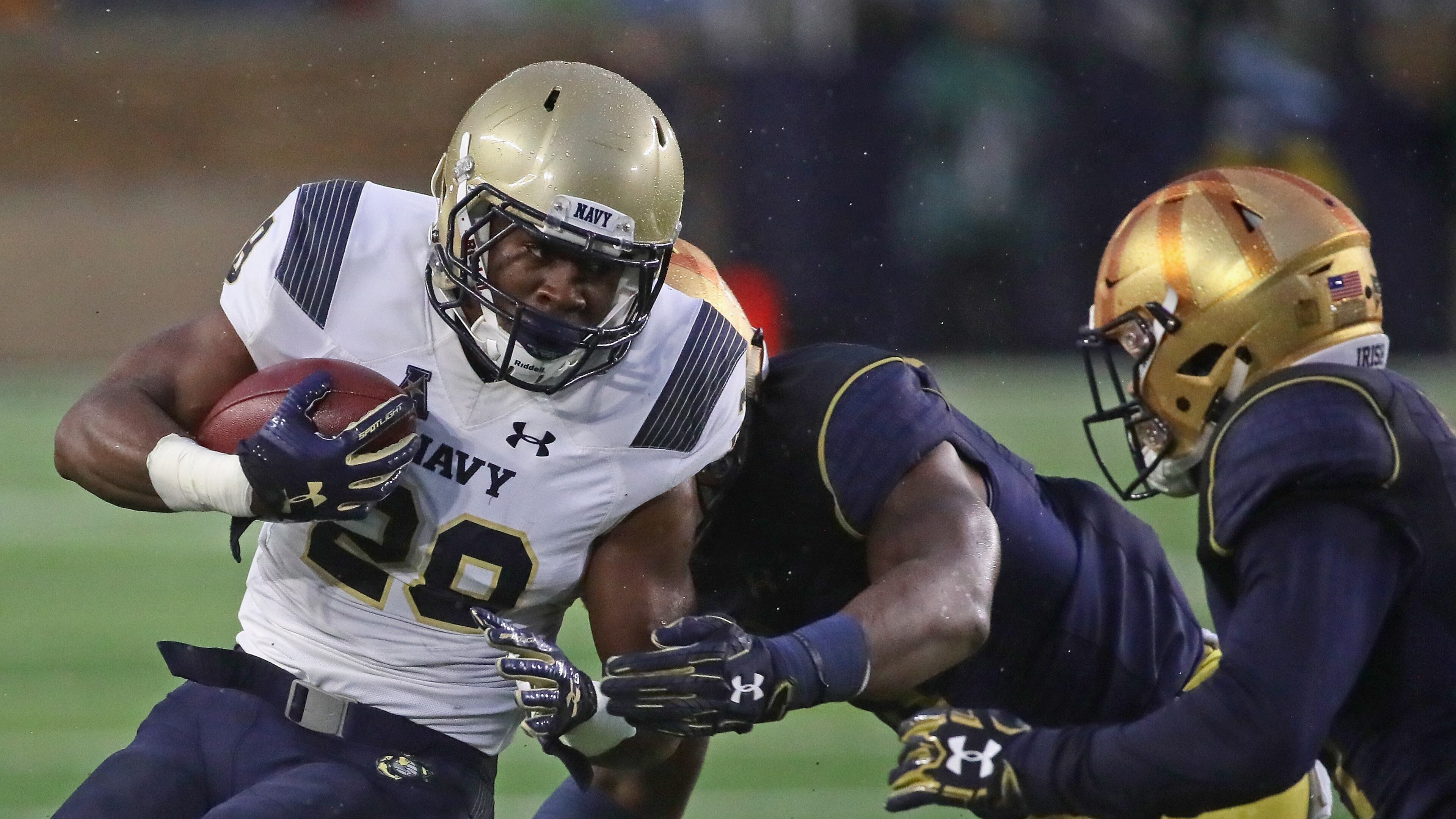 Josh Brown of Navy is hit by Daelin Hayes (center) and Shaun Crawford of Notre Dame at Notre Dame Stadium on November 18, 2017 in South Bend, Indiana. (Photo by Jonathan Daniel/Getty Images)