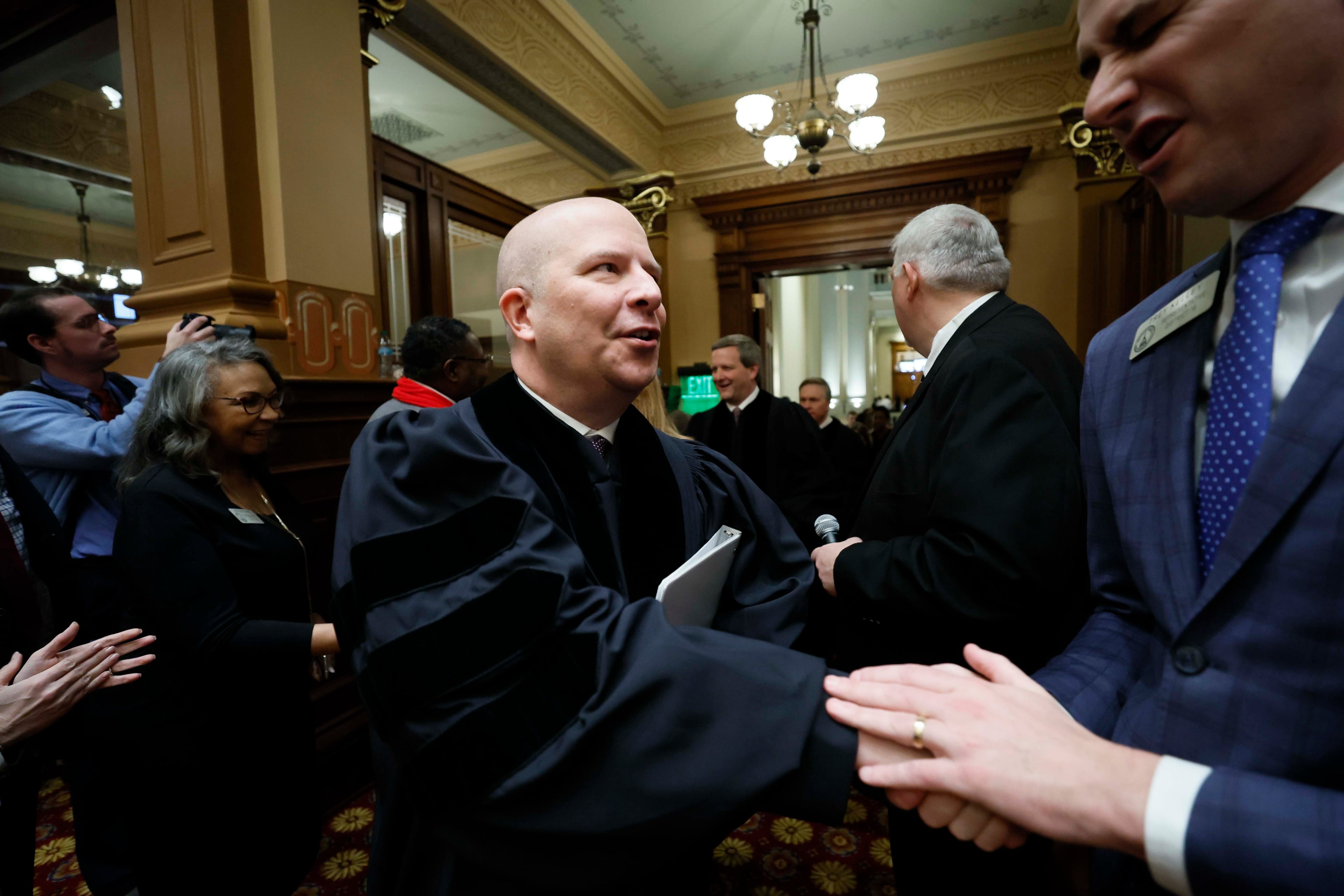 Chief Justice Nels Peterson greets lawmakers as he enters the house chamber ahead of his State of the Judiciary address on Wednesday, Feb. 4, 2026. (Miguel Martinez/AJC)