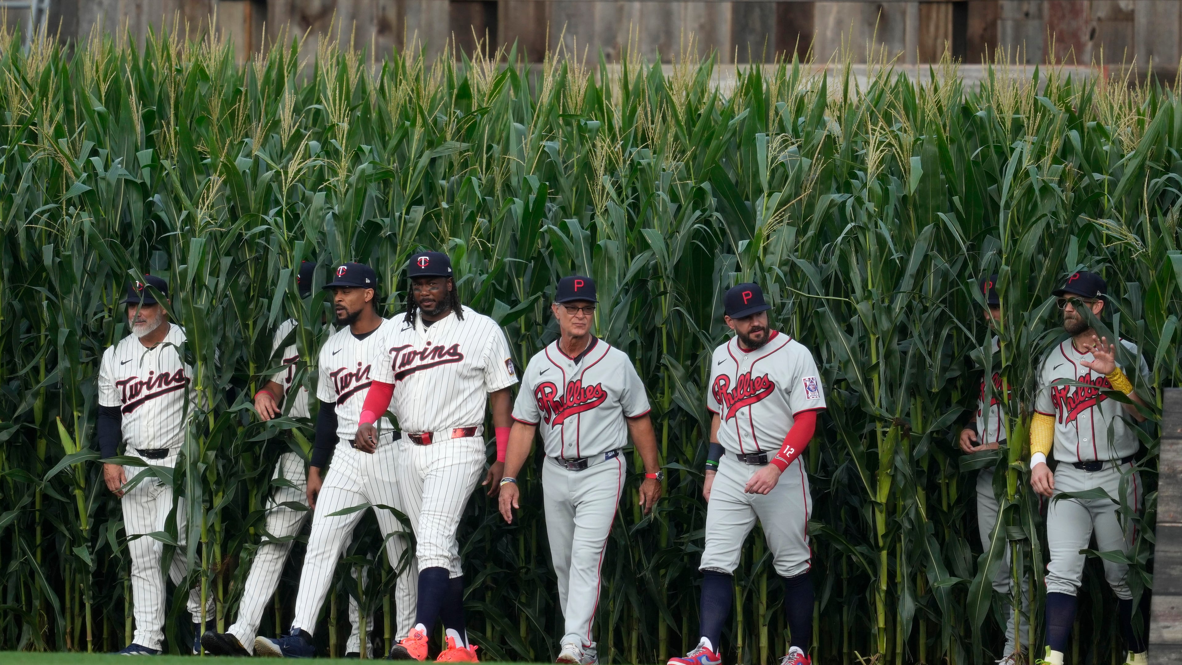 Players walk onto the field before a baseball game between the Minnesota Twins and the Philadelphia Phillies at the Field of Dreams movie site, Thursday, Aug. 13, 2026, in Dyersville, Iowa. (AP Photo/Charlie Neibergall)