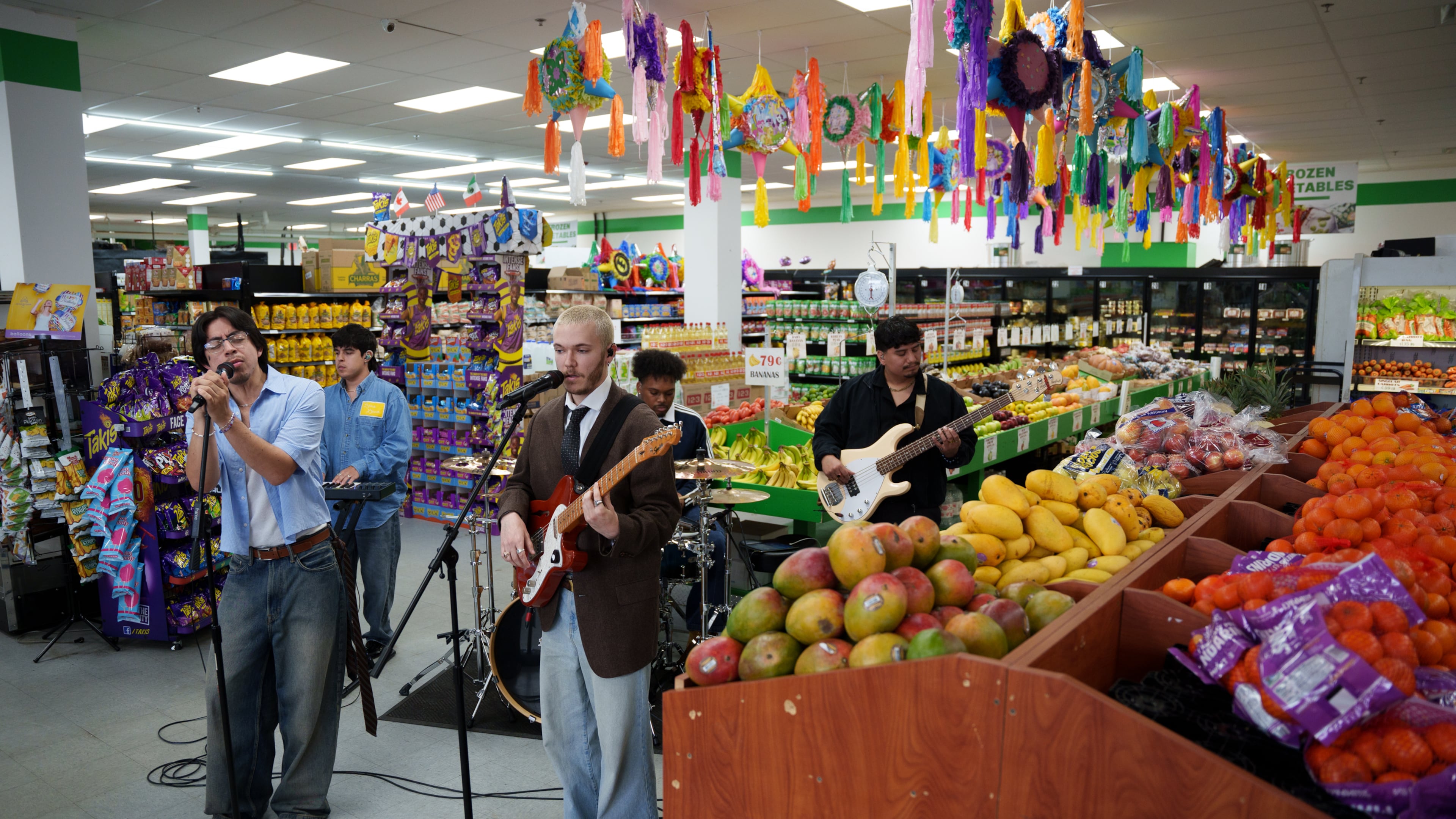 Bilingual alternative pop band Luna Luna performs in the produce section of Fiesta Fresh Market in New Castle, Del., on Sunday, April 26, 2026. (AP Photo/Mingson Lau)