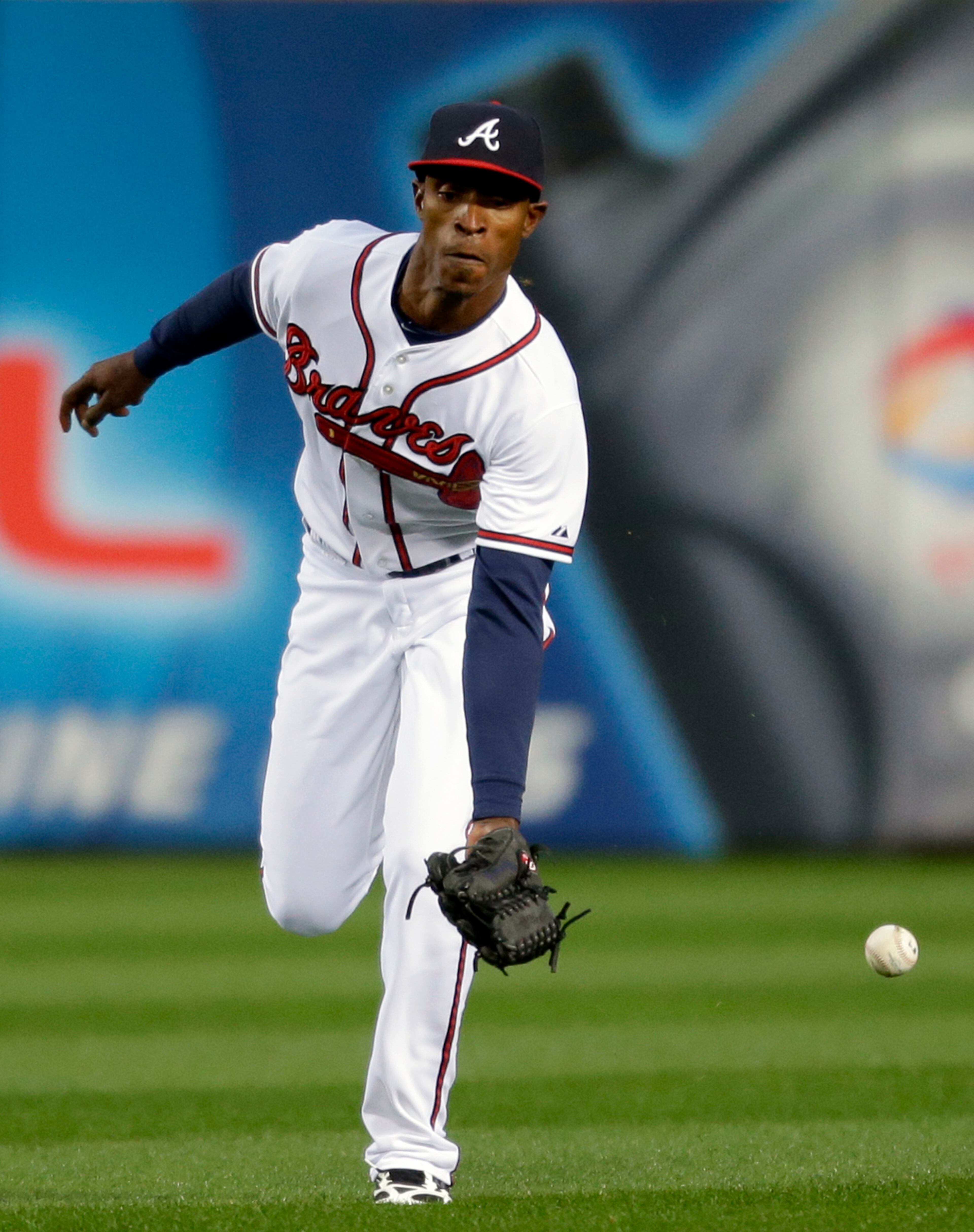 Atlanta Braves' B.J. Upton misses the catch on a single hit by Philadelphia Phillies' Jimmy Rollins in the first inning.