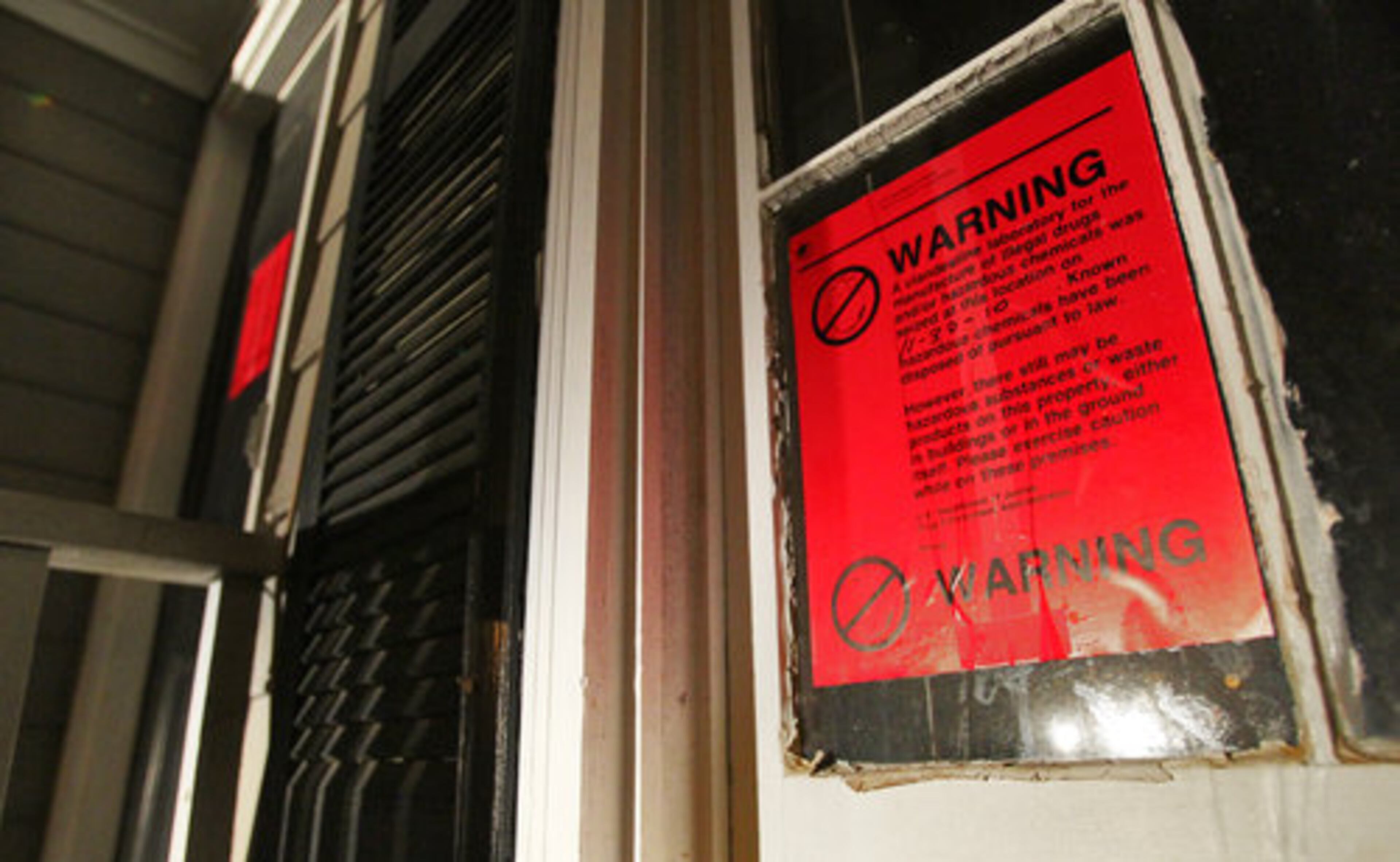 The home at 3355 Newbury Road in Norcross was sealed with warning labels after law enforcement agents completed an investigation Tuesday, Nov. 30, 2010. Authorities in hazmat suits spent the night removing items from a suspected drug house.