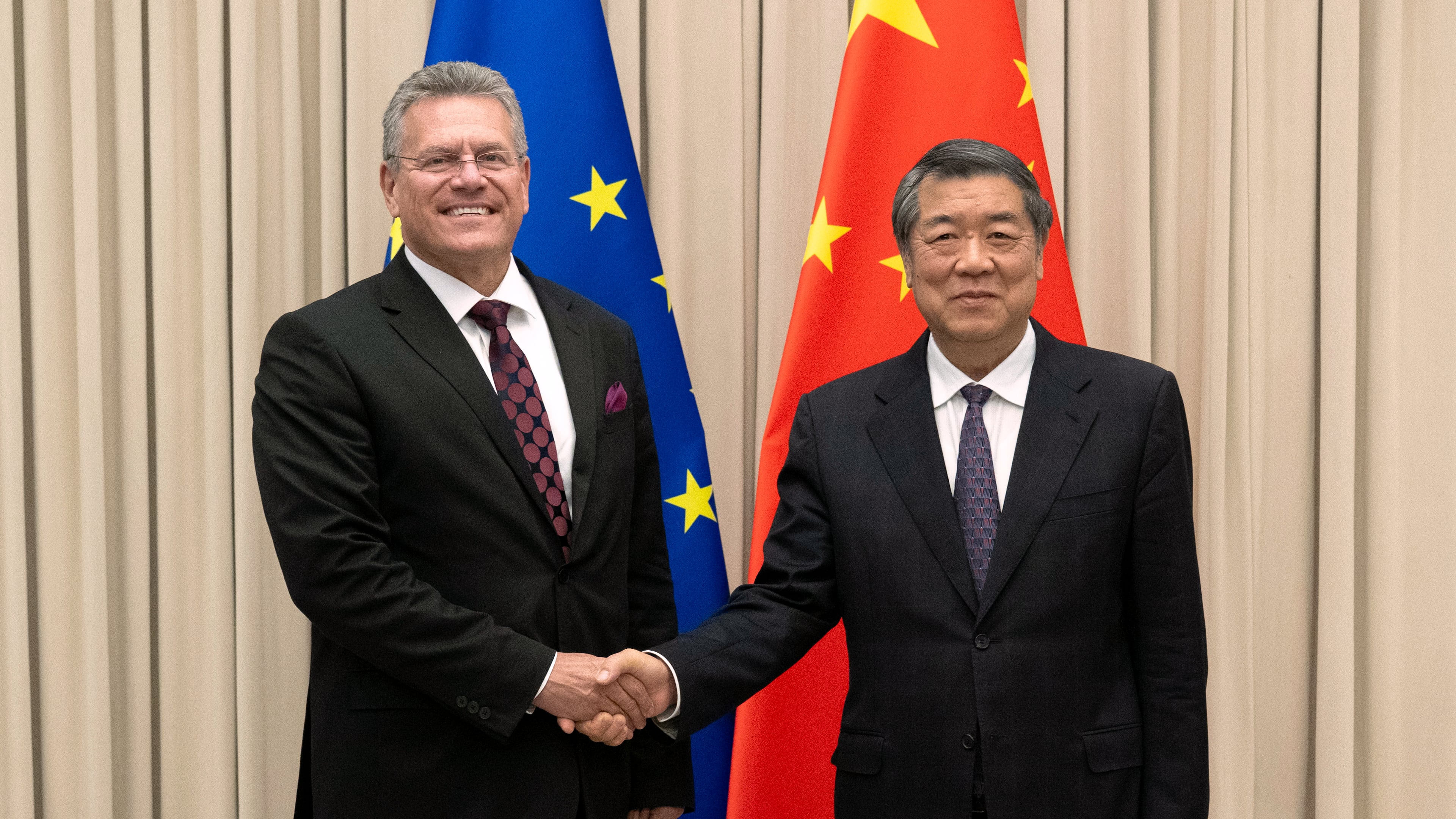In this photo released by the Xinhua News Agency, Chinese Vice Premier He Lifeng, right, shakes hands with European Commissioner for Trade and Economic Security Maros Sefcovic prior to their meeting in Beijing, Friday, Oct. 9, 2026. (Tian Yu/Xinhua via AP)