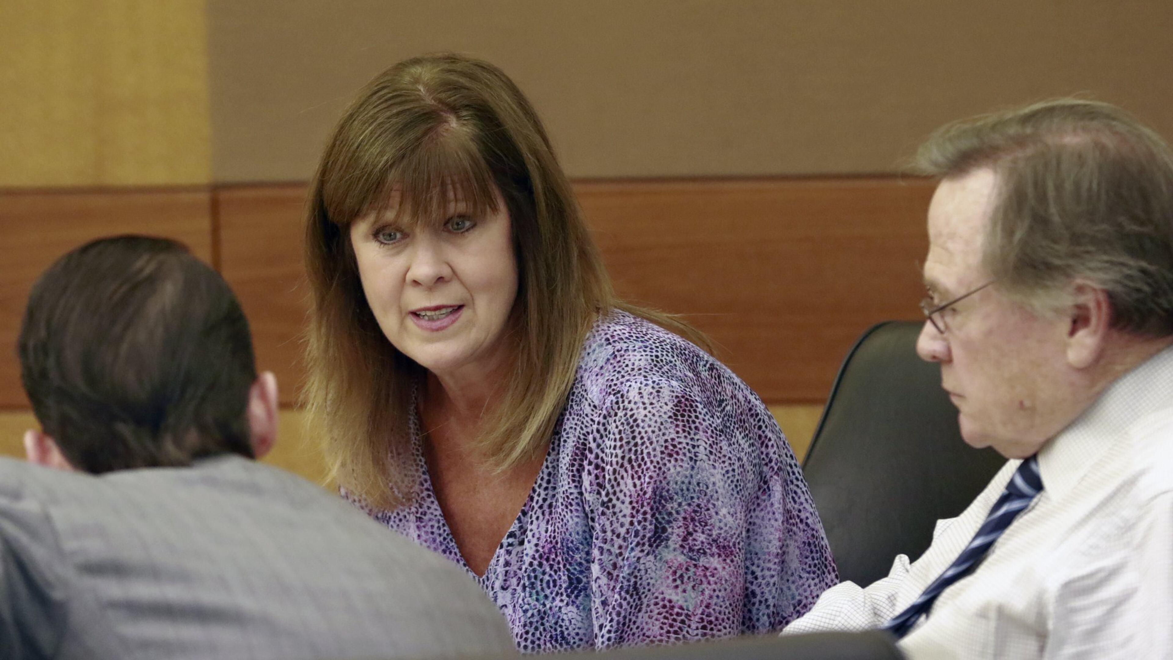 Jana Thompson talks with her attorneys, John (left) and Ed Garland on Aug. 31, 2016. Thompson, 58, is on trial for second-degree murder in the death of 3-year-old Max Stephens. She is accused of leaving the child outside and unsupervised long enough for him to hang himself with a piece of twine. BOB ANDRES /BANDRES@AJC.COM