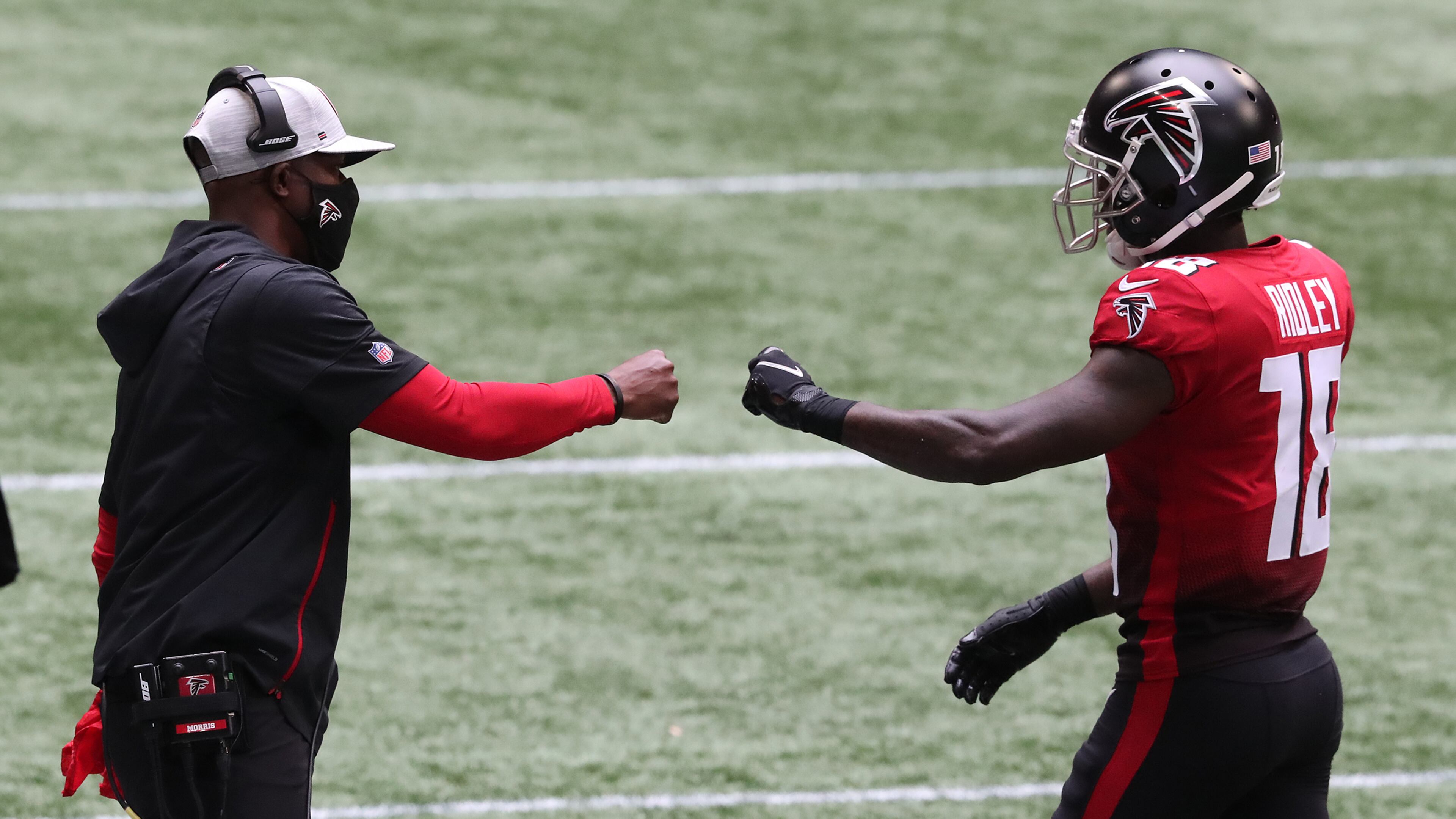 Falcons interim head coach Raheem Morris (left) greets wide receiver Calvin Ridley with a fist-bump on the sidelines after Ridley's second-quarter touchdown catch against the Detroit Lions Sunday, Oct. 25, 2020, at Mercedes-Benz Stadium in Atlanta. (Curtis Compton / Curtis.Compton@ajc.com)