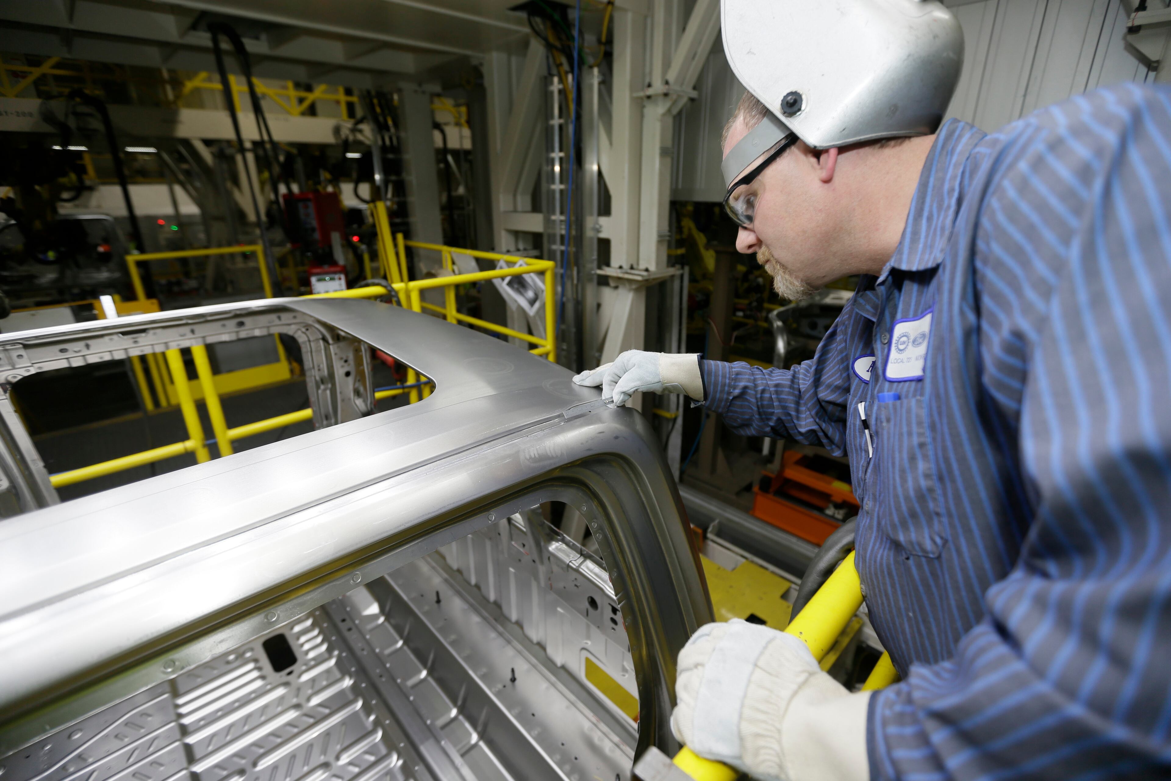 Ron Hudgin measures the roof line of the F-150 truck at the Rouge Truck Plant in Dearborn, Mich. It's the automaker's biggest bet in decades: an aluminum-sided F-150 that could set a new industry standard _ or cost the company its pickup truck crown. It will arrive on U.S. dealer lots next month. Aluminum _ which is lighter than steel but just as strong _ isn't new to the auto industry, but this is the first time it will cover the entire body of such a high-volume vehicle. (AP Photo/Carlos Osorio)