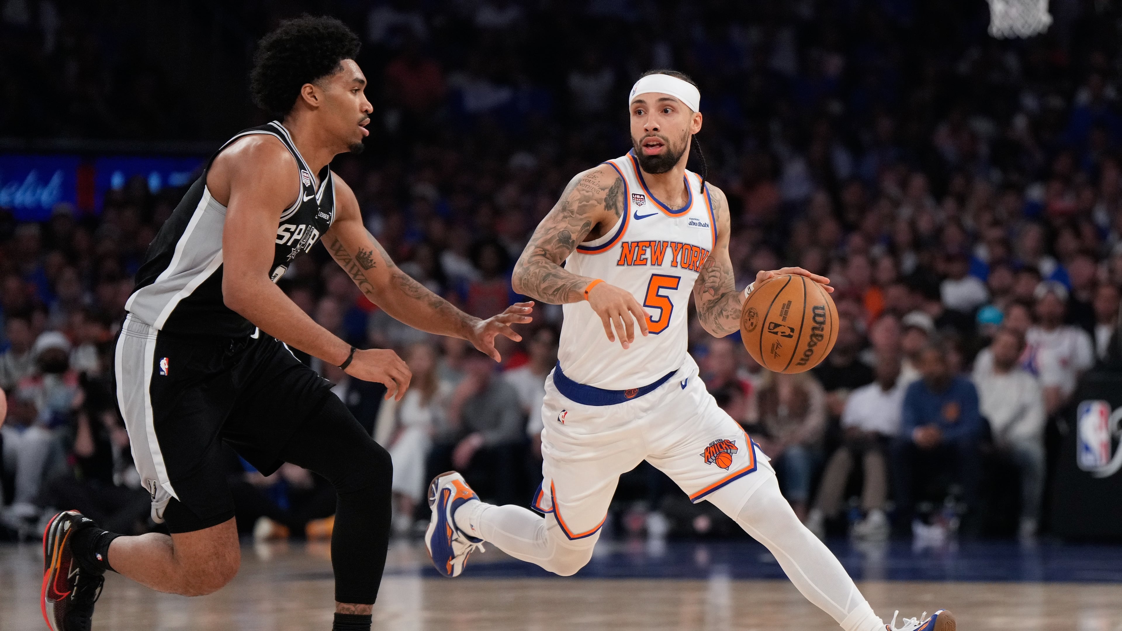 New York Knicks guard Jose Alvarado (5) drives as San Antonio Spurs guard Dylan Harper defend during the first half of Game 4 of the NBA Finals basketball series, Wednesday, June 10, 2026, in New York. (AP Photo/Ross D. Franklin)