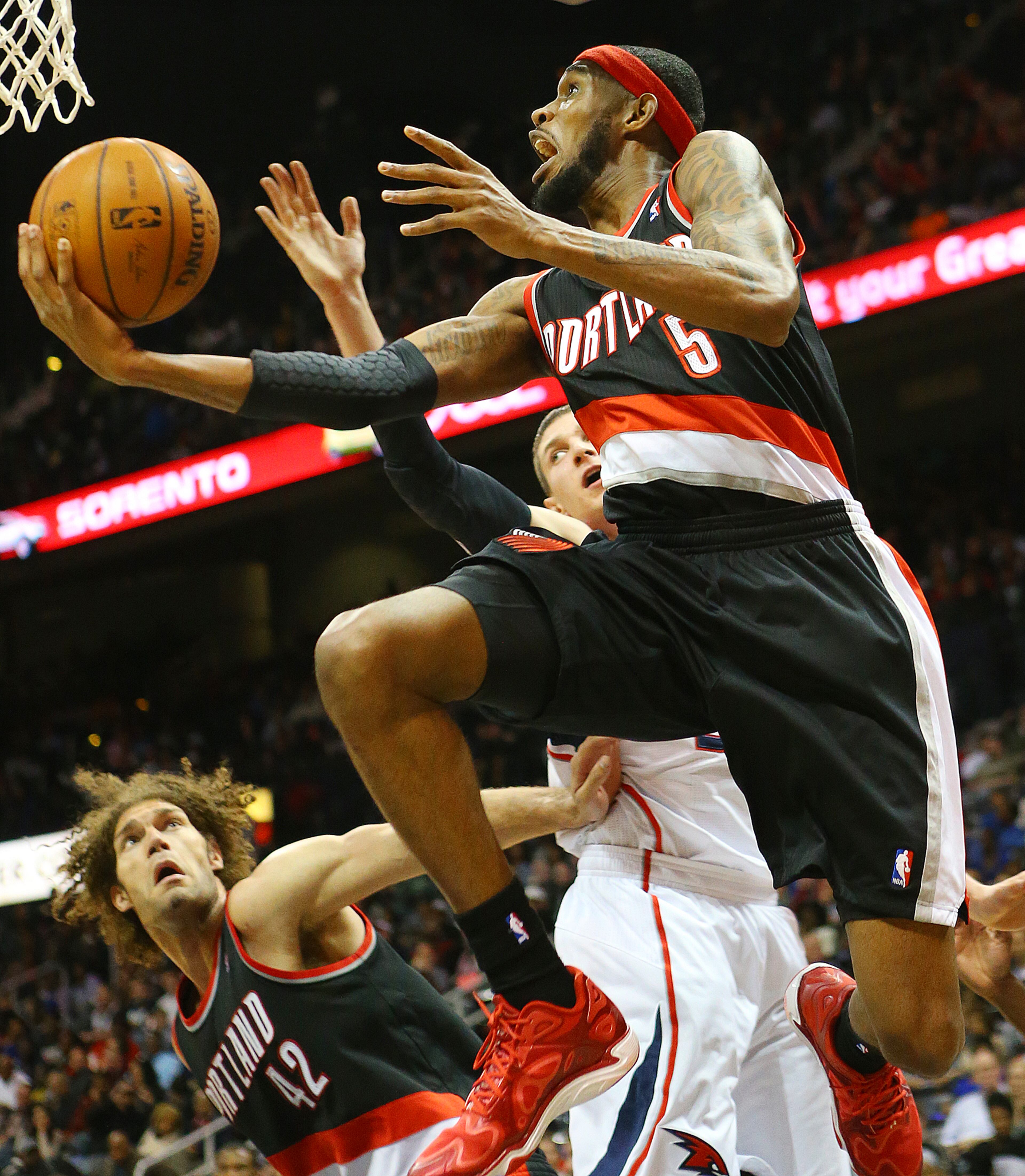 Trail Blazers guard Will Barton gets past Hawks forward Mike Muscala for two points during the second half of an NBA basketball game on Thursday, March 27, 2014, in Atlanta. The Trail Blazers won 100-85. CURTIS COMPTON / CCOMPTON@AJC.COM