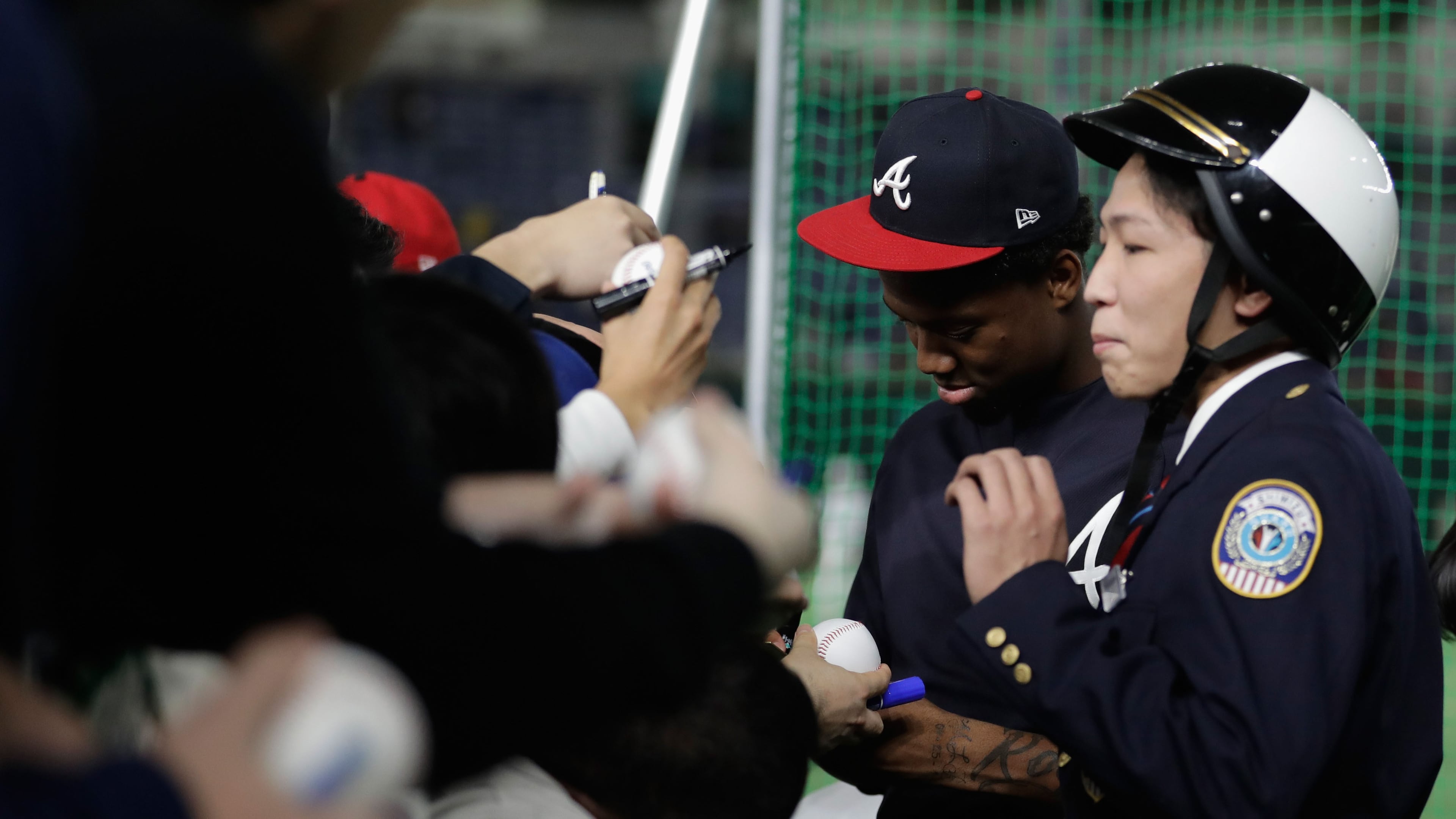 Braves outfielder Ronald Acuna signs autographs for fans prior to the game two of the Japan and MLB All Stars Nov. 10, 2018, at Tokyo Dome in Tokyo.