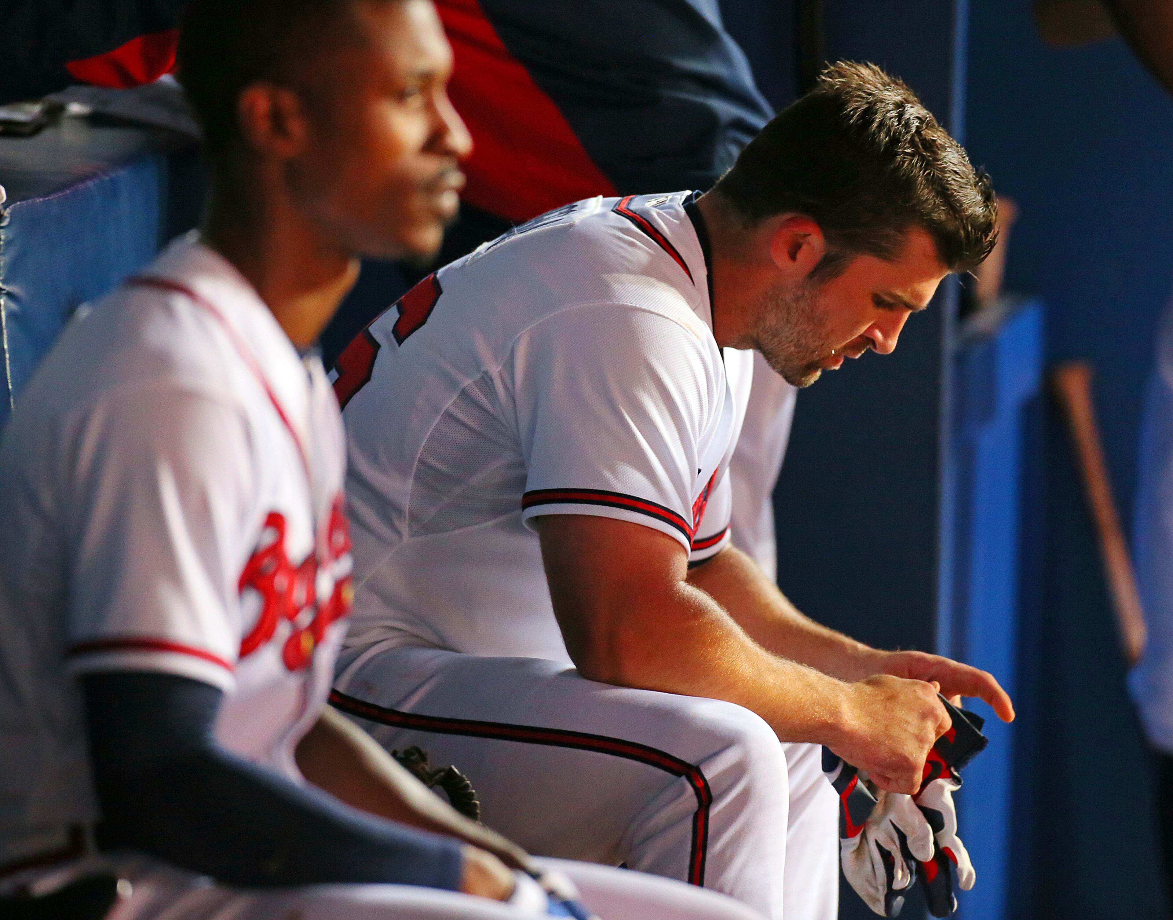 B.J. Upton (left) and Dan Uggla sit in the dugout dejected as the Braves fall to the Nationals.