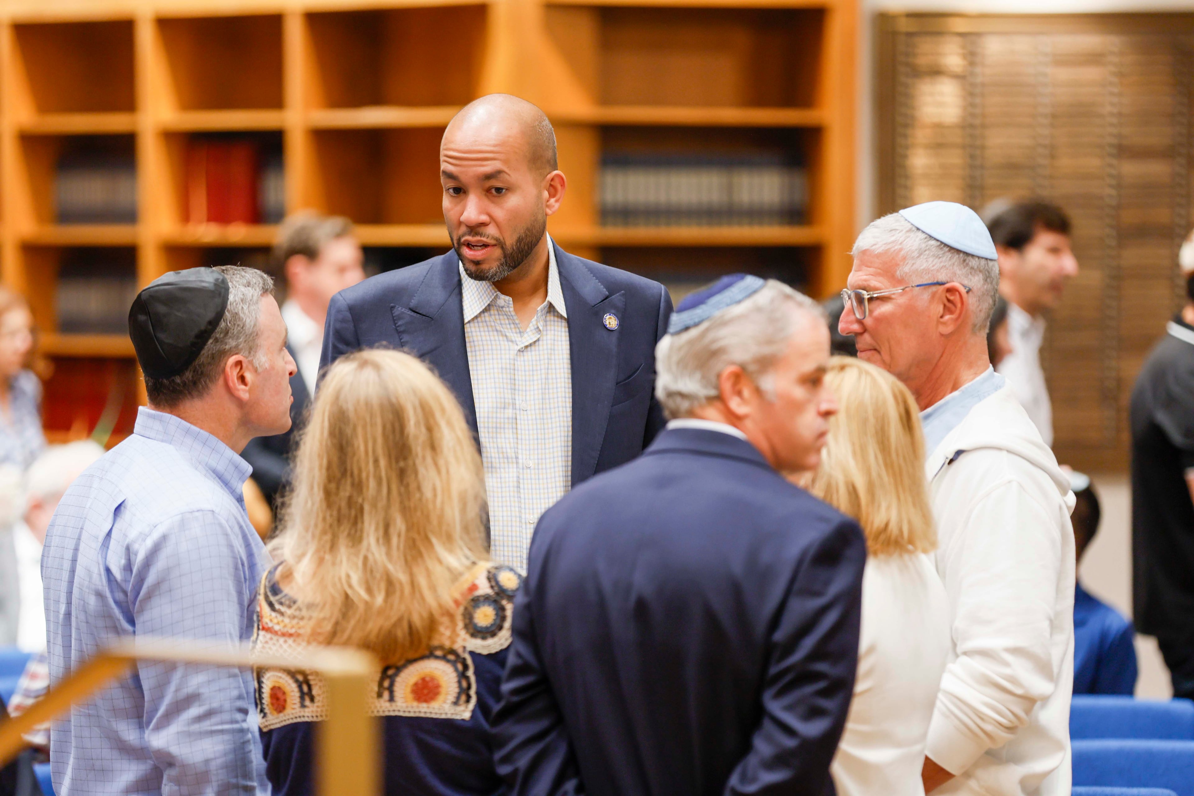 Democratic gubernatorial candidate Jason Esteves (center) is seen talking with members of the Jewish community at the Ahavath Achim Synagogue as the community gathers on Sunday, Oct. 5, 2025, to commemorate the second anniversary of the Oct. 7 attacks. (Miguel Martinez/AJC)