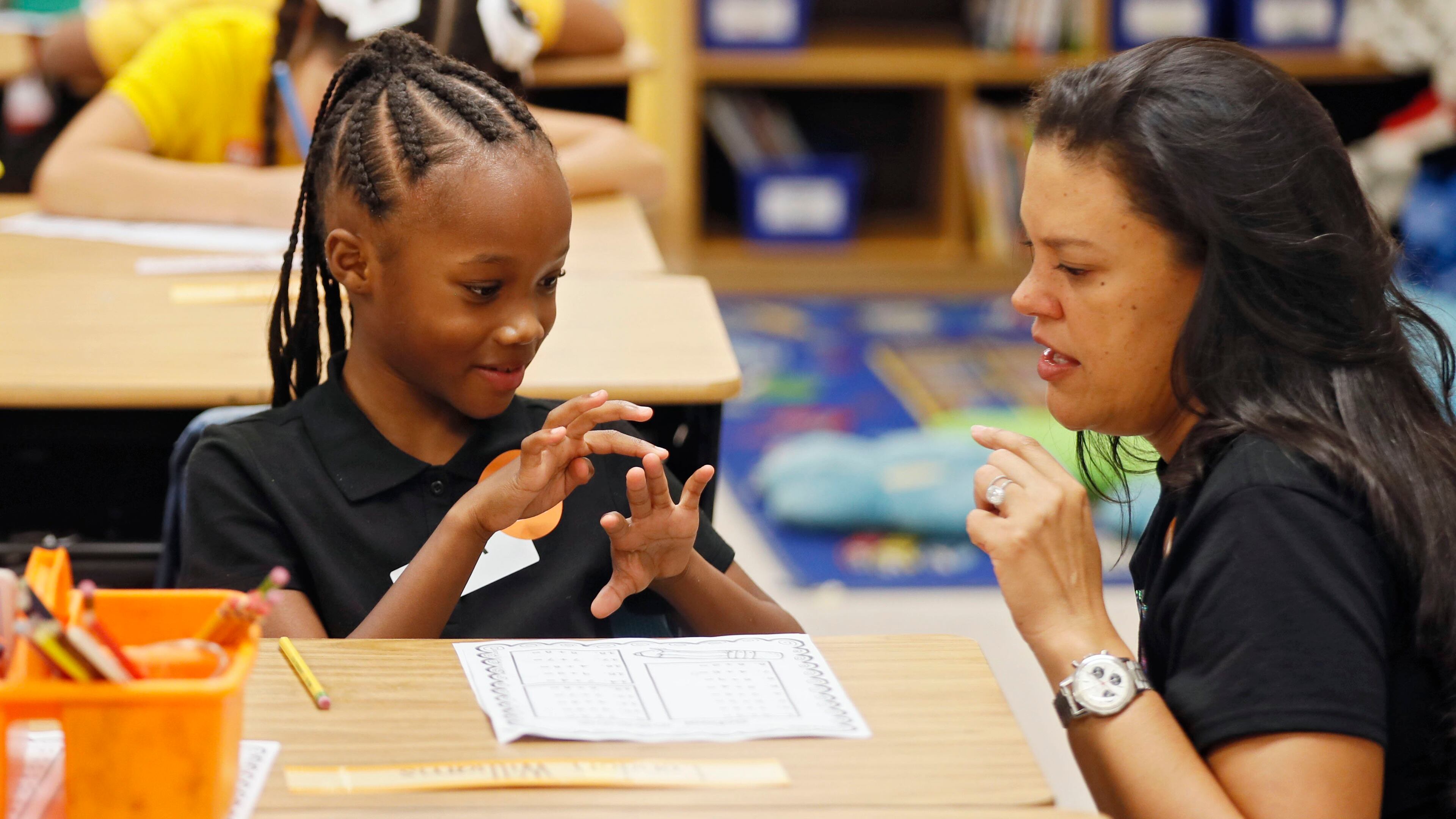 8/1/18 - Atlanta - Superintendent Meria Carstarphen, helps London Williams with her math assignment in Hannah Reisman's class. It was the first day of school at Peyton Forest Elementary school, which is celebrating its 50th anniversary. Teachers and staff welcomed the kids with a circus theme. BOB ANDRES /BANDRES@AJC.COM