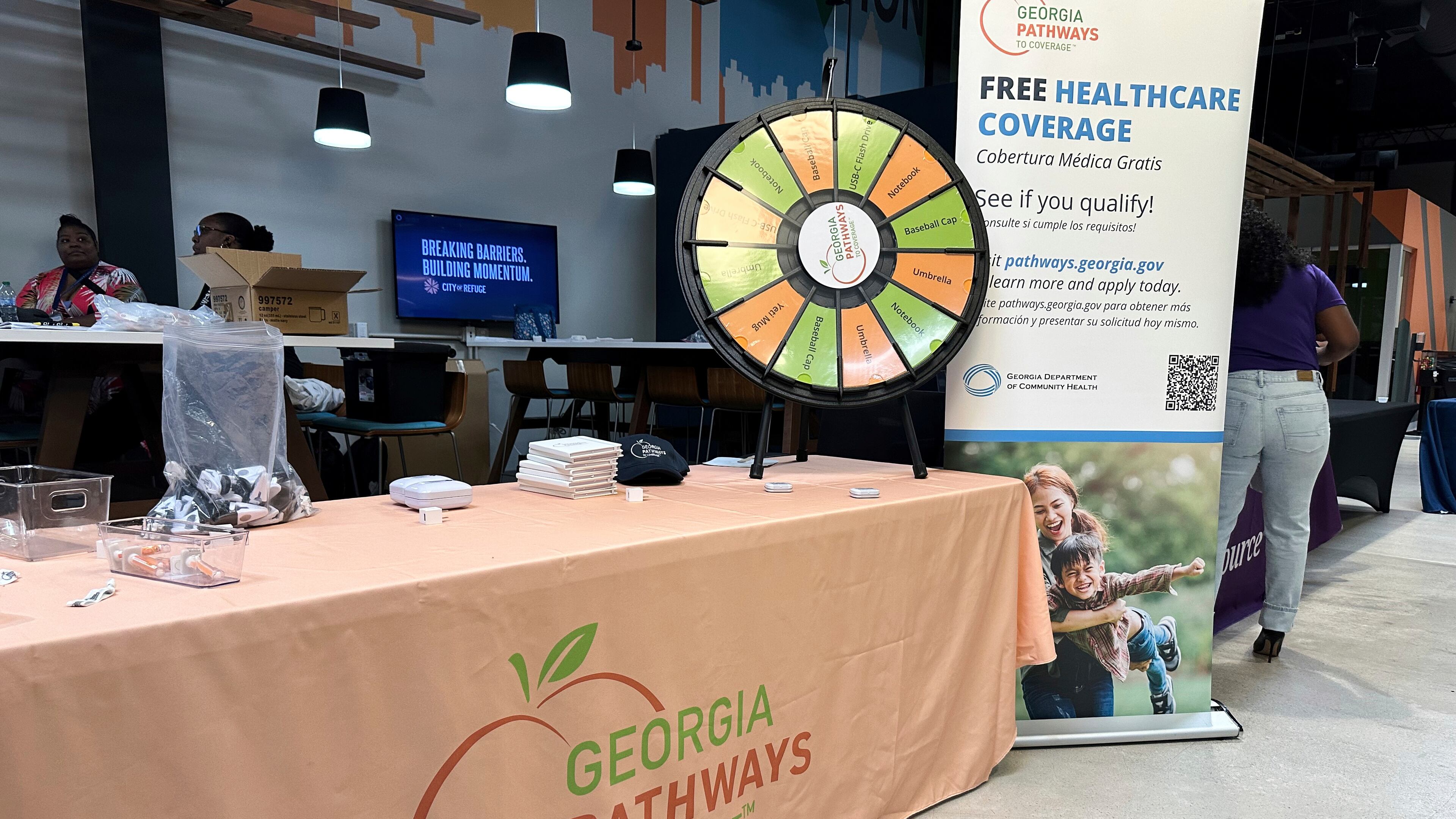 FILE - A stand for Georgia Pathways is seen at a job fair in Atlanta, Ga., June 5, 2025. (AP Photo/Sudhin Thanawala, File)