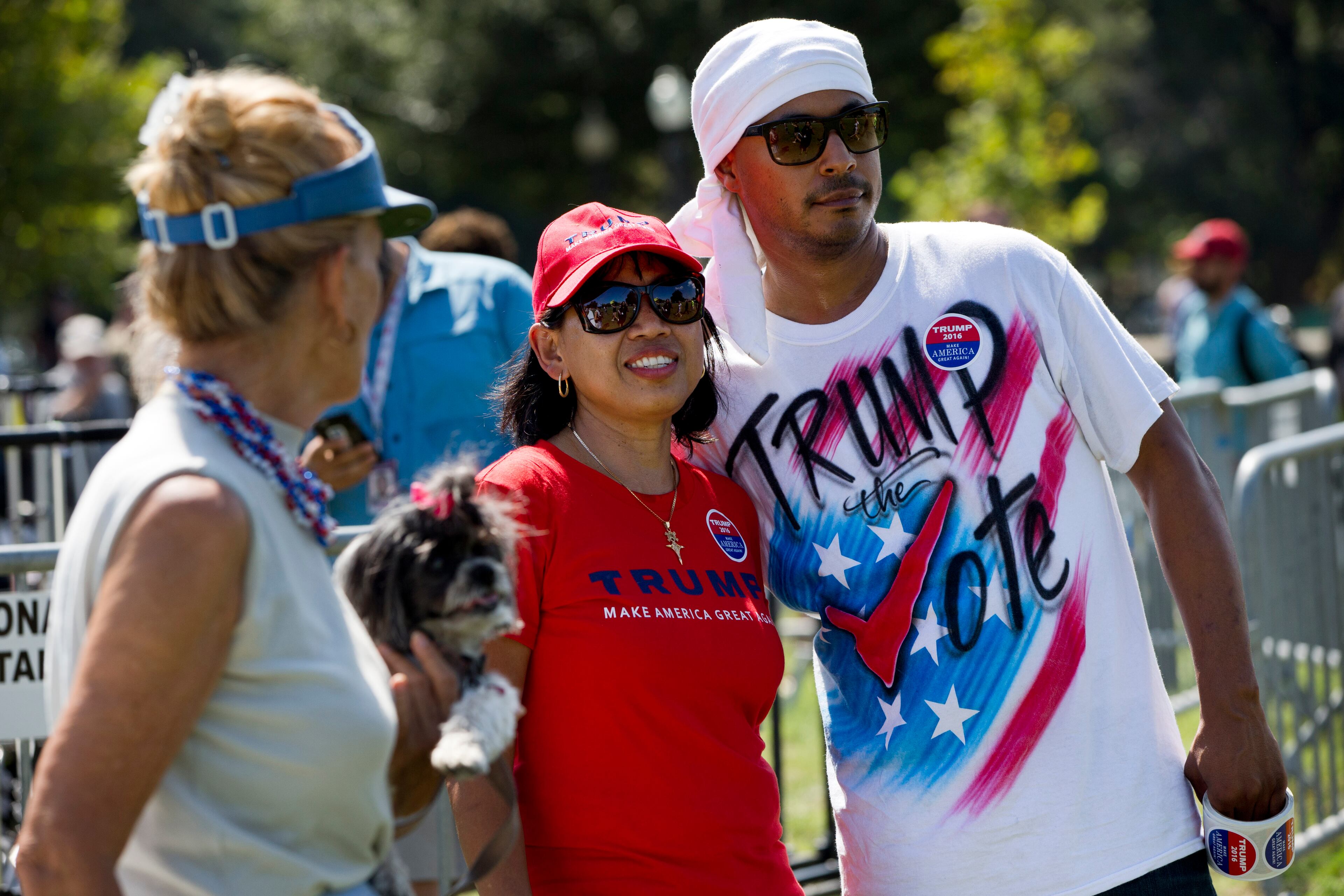 Ratih Hughes, left, of Berkeley Springs, W.Va., who calls herself a "Retrumplican," hugs Eli Valentine, of Hampton Roads, Va., as he wears a "Trump the Vote" shirt at the start of a Tea Party rally against the Iran deal on the West Lawn of the Capitol in Washington, Wednesday Sept. 9, 2015. The rally is expected to be attended by Republican presidential candidates Sen. Ted Cruz, R-Texas, and Donald Trump. (AP Photo/Jacquelyn Martin)