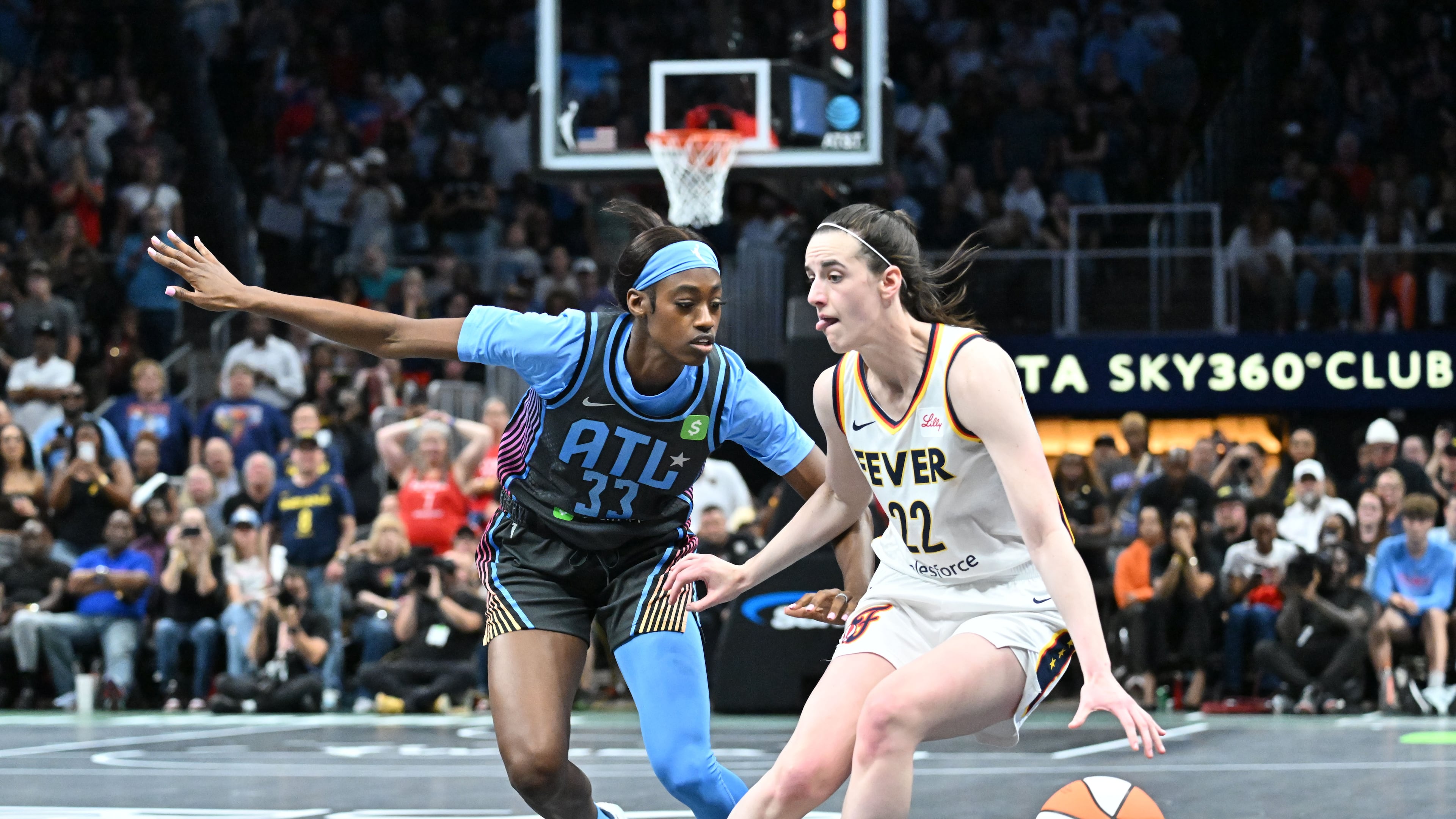 Indiana Fever guard Caitlin Clark (22) drives against Atlanta Dream guard Maya Caldwell (33) during the second half in Atlanta Dream’s home opener at State Farm Arena, Thursday, May 22, 2025, in Atlanta. Indiana Fever won 81-76 over Atlanta Dream. (Hyosub Shin / AJC)