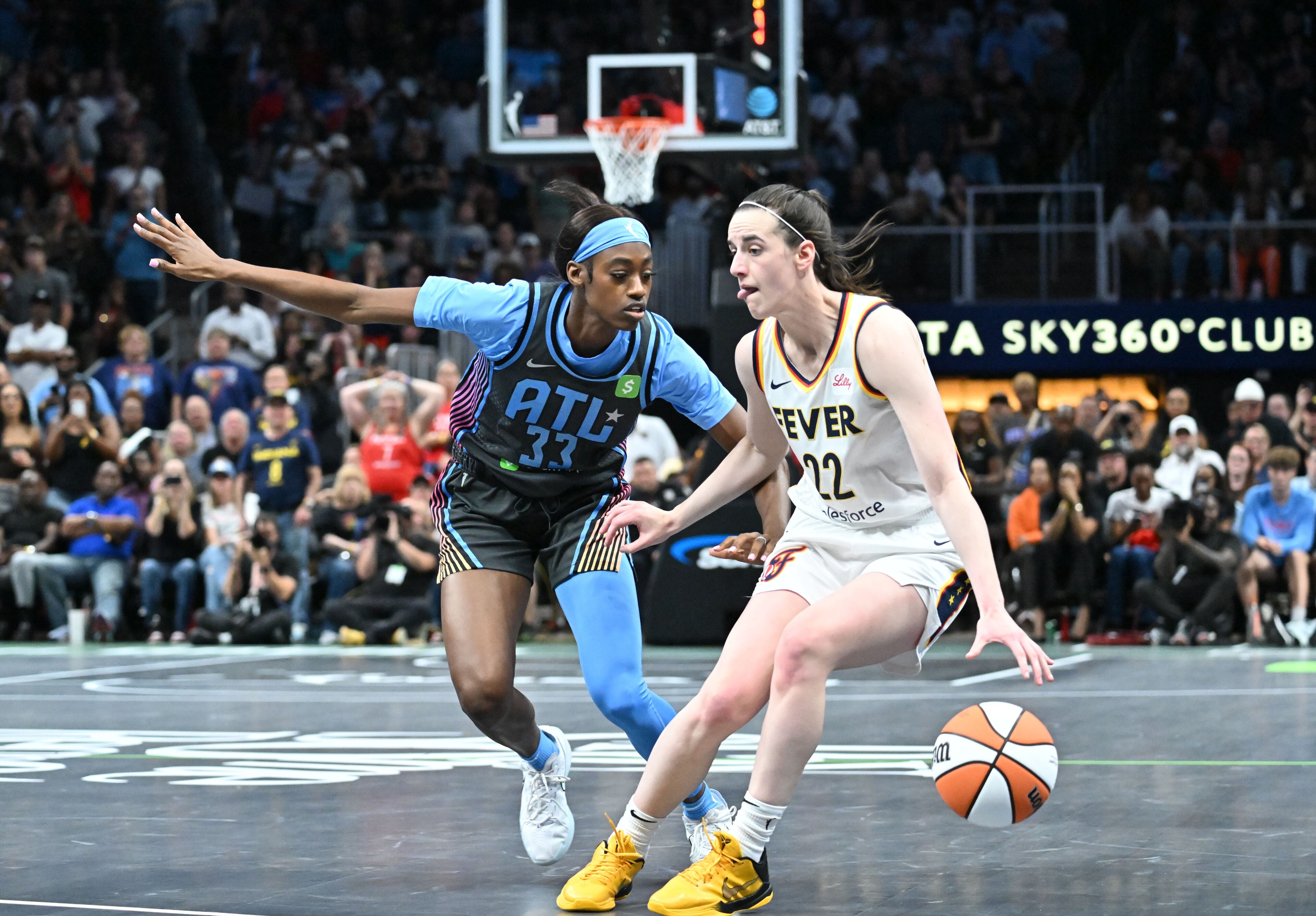 Indiana Fever guard Caitlin Clark (22) drives against Atlanta Dream guard Maya Caldwell (33) during the second half in Atlanta Dream’s home opener at State Farm Arena, Thursday, May 22, 2025, in Atlanta. Indiana Fever won 81-76 over Atlanta Dream. (Hyosub Shin / AJC)