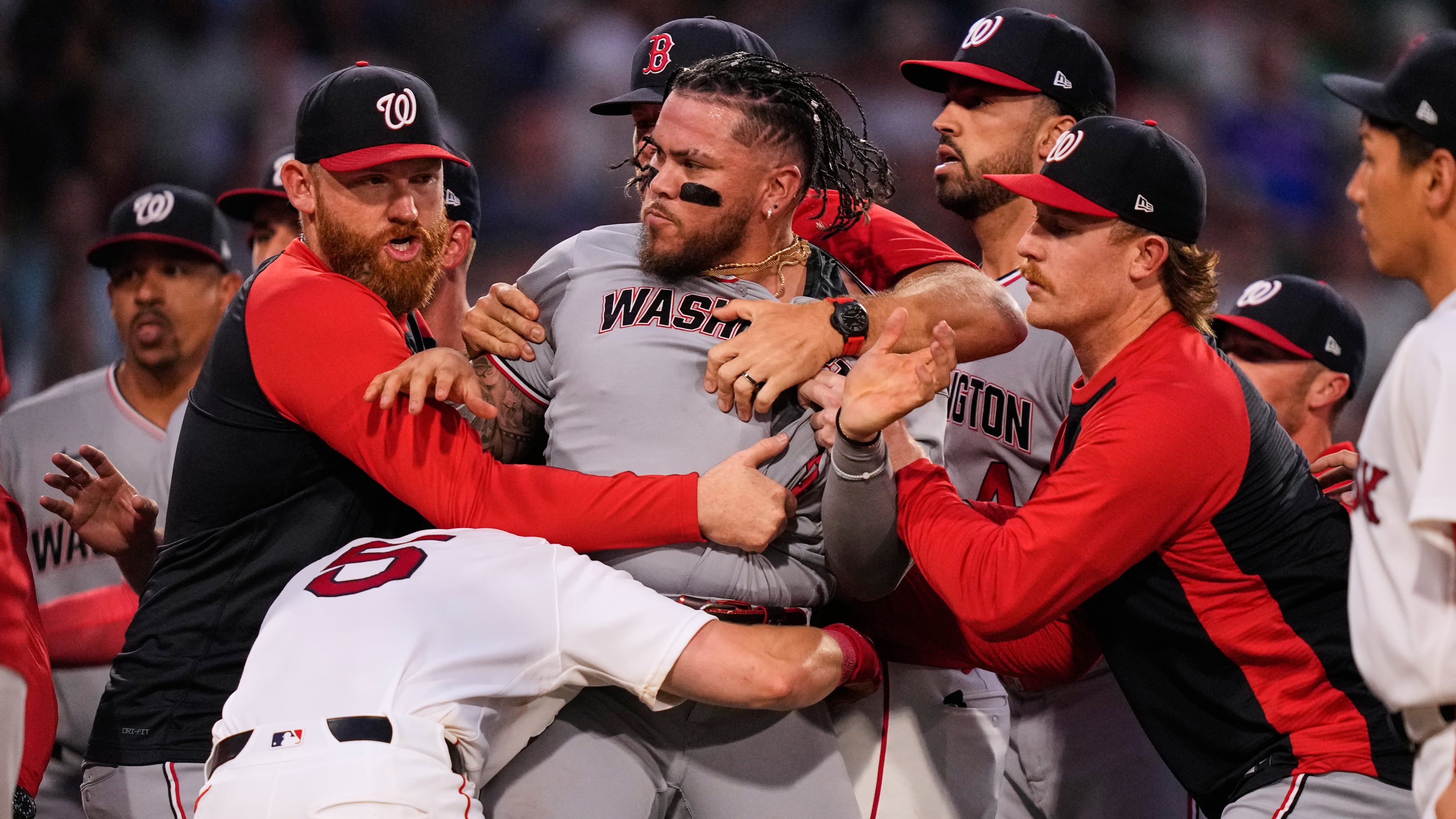 Washington Nationals' Andrés Chaparro, center, is held back as tempers flare during the fourth inning of a baseball game against the Boston Red Sox, Tuesday, June 30, 2026, in Boston. (AP Photo/Charles Krupa)