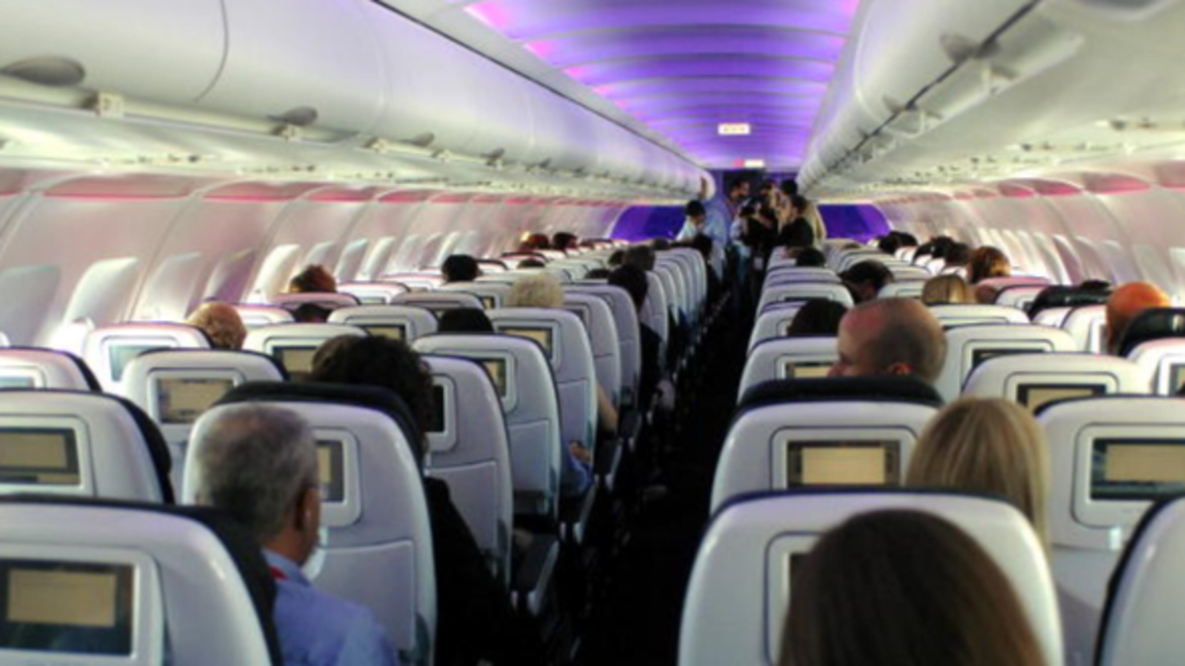 Passengers are pictured aboard an airliner, similar to a flight last week between Israel and Brussels, when a screaming boy was disrupting the flight. A worried woman thought he might cause an emergency landing so she took matters into her own hands and managed to soothe the boy.