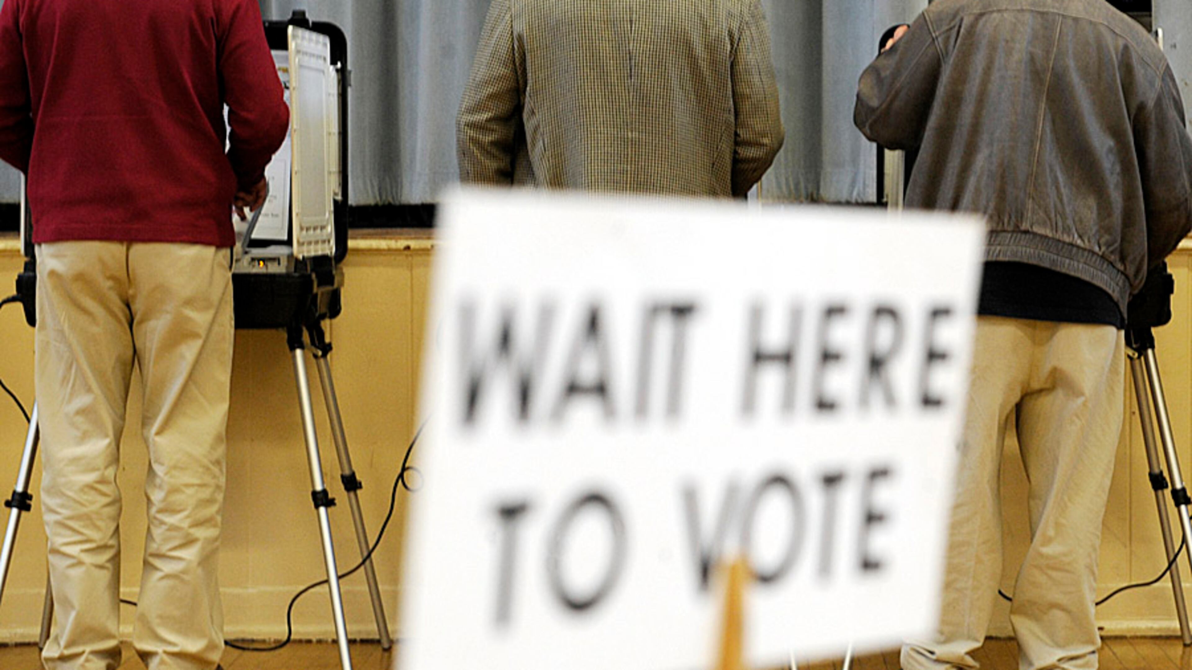 Voters stand at their individual booths at Morningside Elementary School in Atlanta Tuesday, Nov 3, 2009.