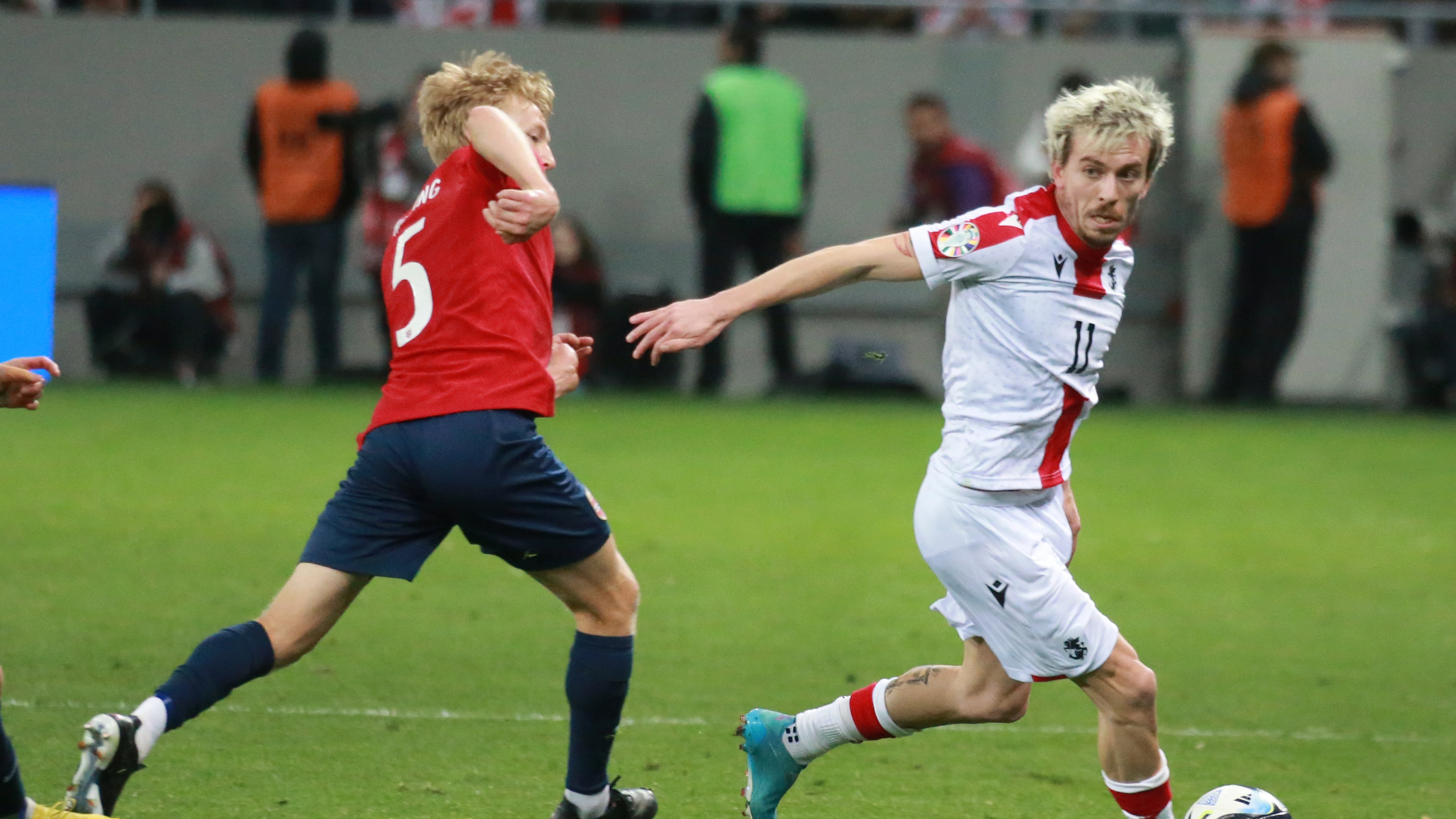 Georgia's Saba Lobjanidze, right, fights for the ball with Norway's Birger Meling during the Euro 2024 group A qualifying soccer match between Georgia and Norway at the AdjaraBet Arena in Batumi, Georgia, Tuesday, March 28, 2023. (AP Photo/Zurab Tsertsvadze)