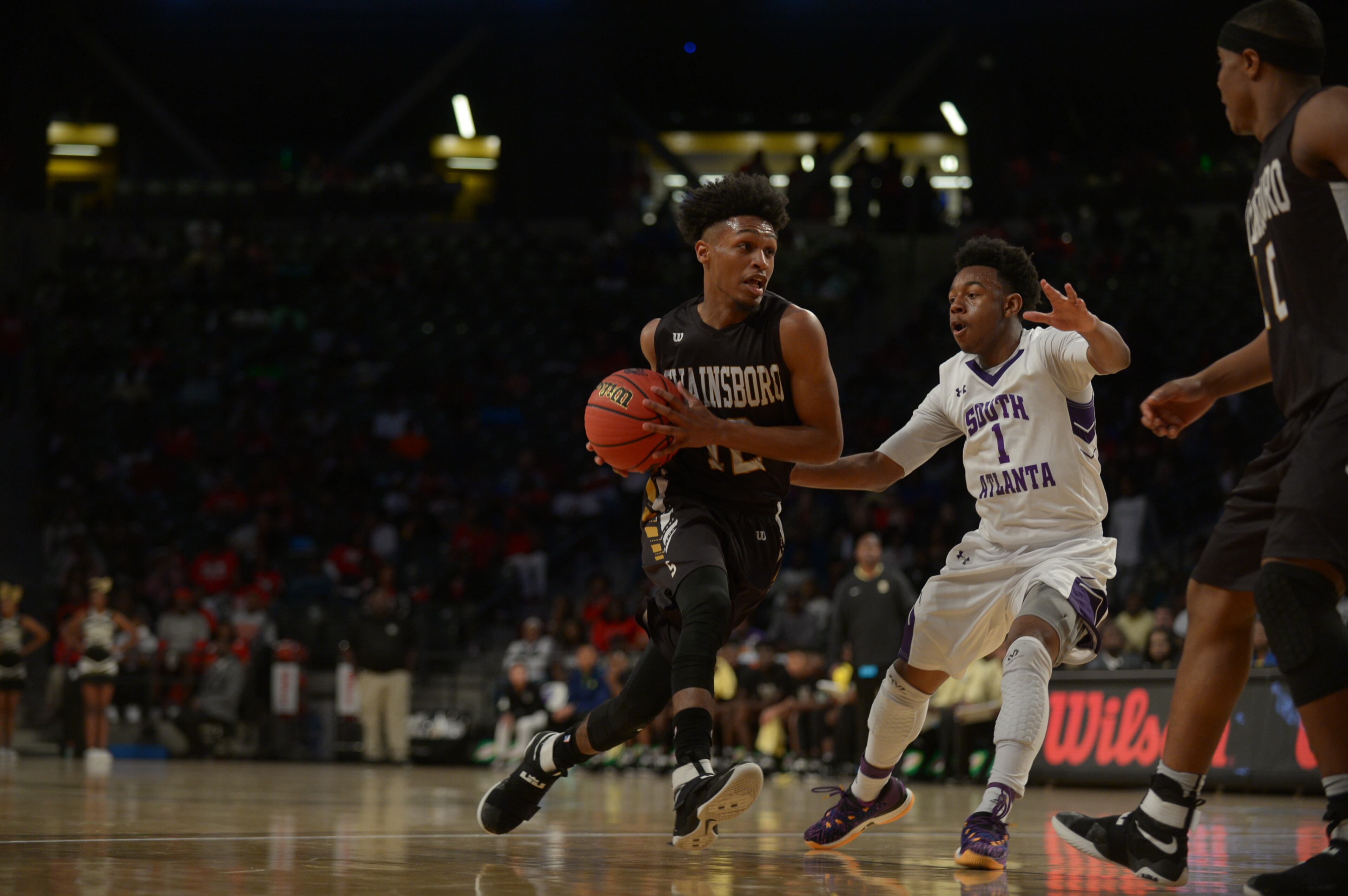 Atlanta, Ga. -- Swainsboro senior Justin Harris (12) drives to the basket against South Atlanta junior Dondre Barnes (1) in the first half of their Class AA state championship game at Georgia Tech's McCamish Pavillion Friday, March 10, 2017. SPECIAL/Daniel Varnado