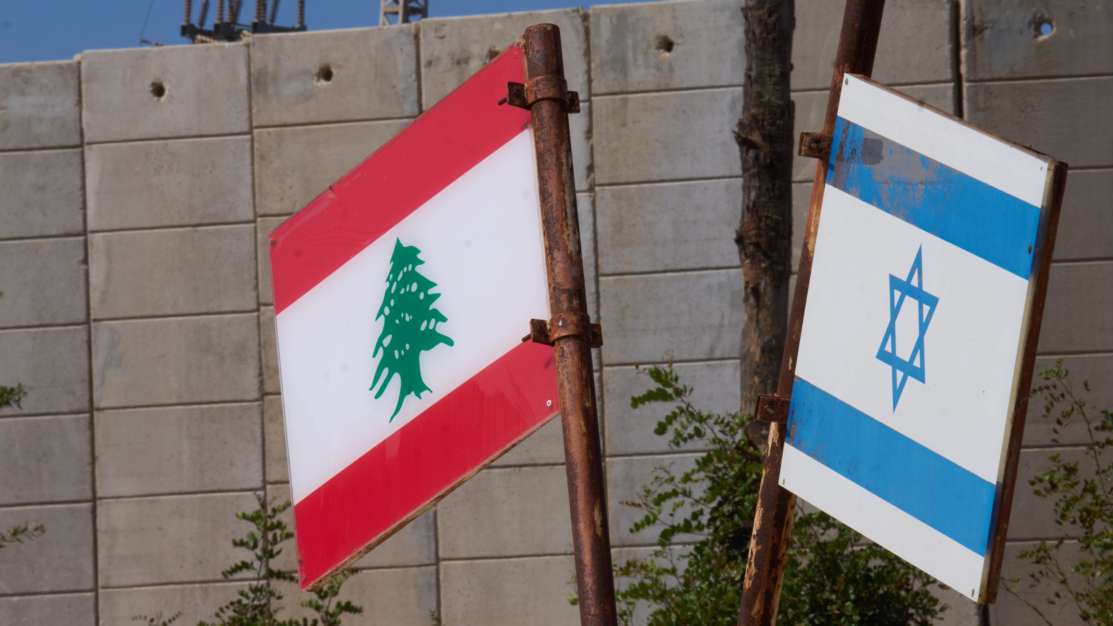 Israeli and Lebanese flags hang in a memorial site on the border with Lebanon in northern Israel, Saturday, June 27, 2026 after Israel and Lebanon sign a framework agreement, described as a first step toward peace following months of conflict between Israel and the Lebanese militant group Hezbollah. (AP Photo/Ariel Schalit)