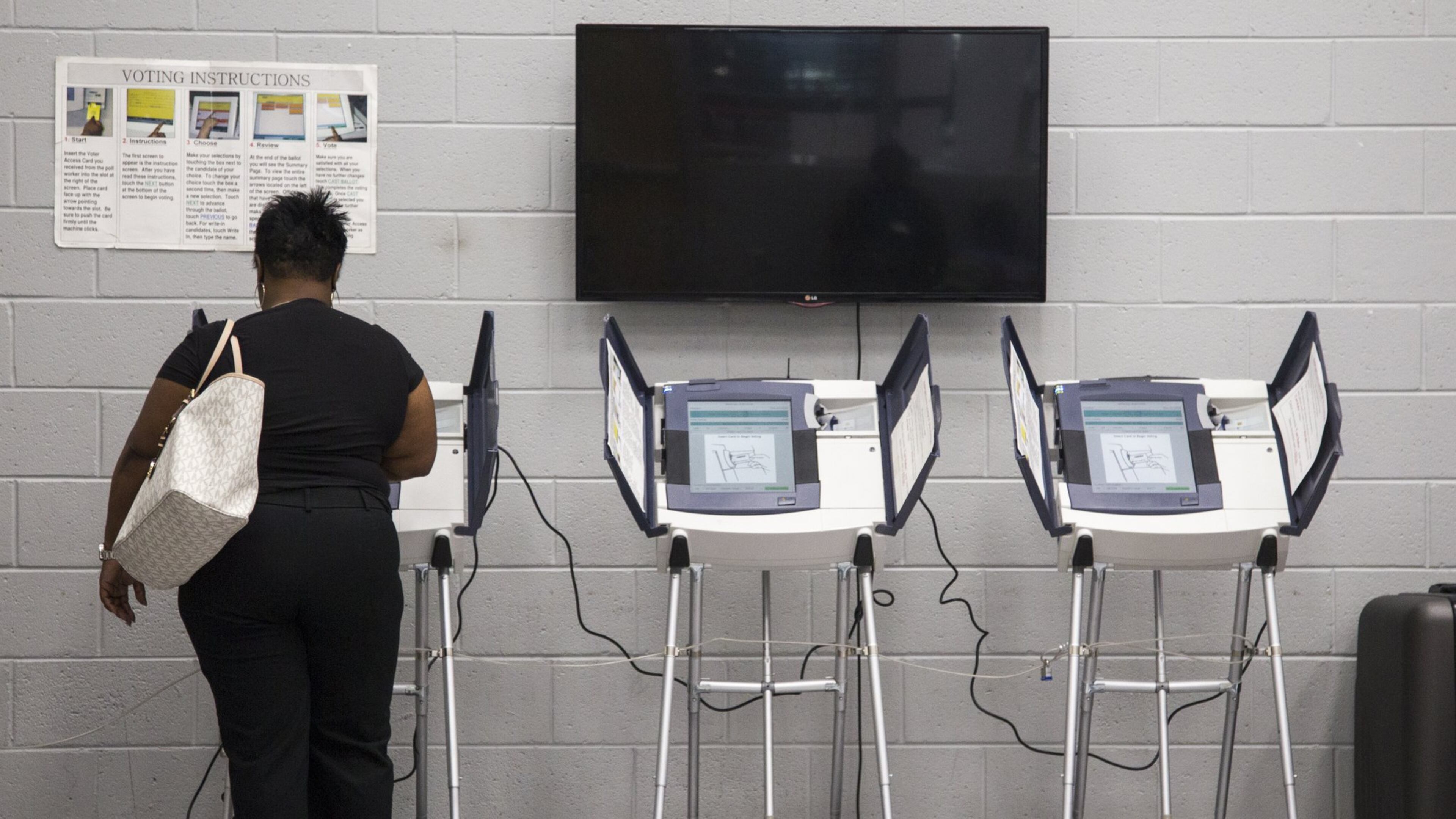 A woman casts her vote during Saturday early voting at the C.T. Martin Natatorium and Recreation Center in Atlanta in May. (REANN HUBER/REANN.HUBER@AJC.COM)